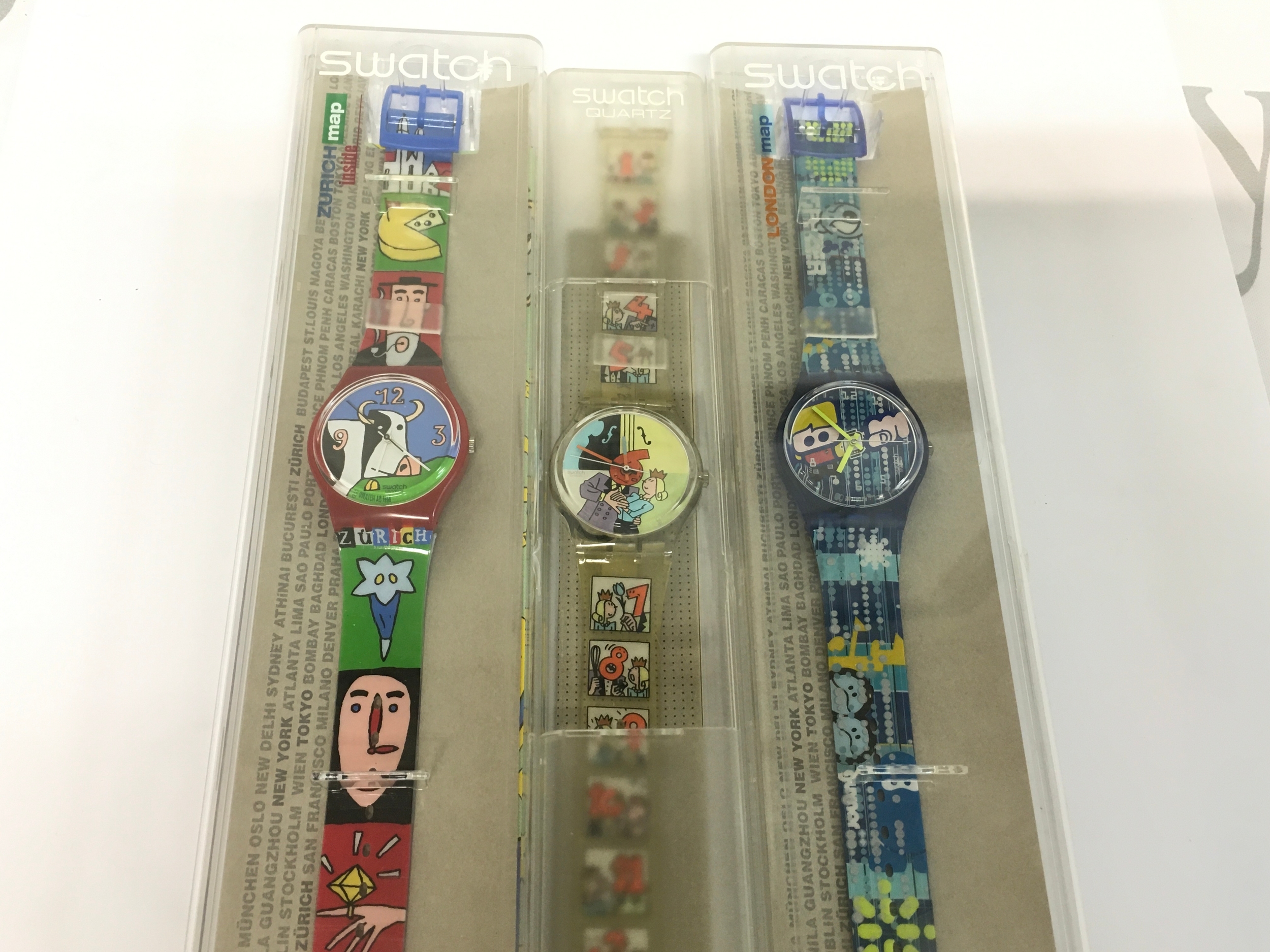 Collection of three vintage Swatch watches including City Map collection version.