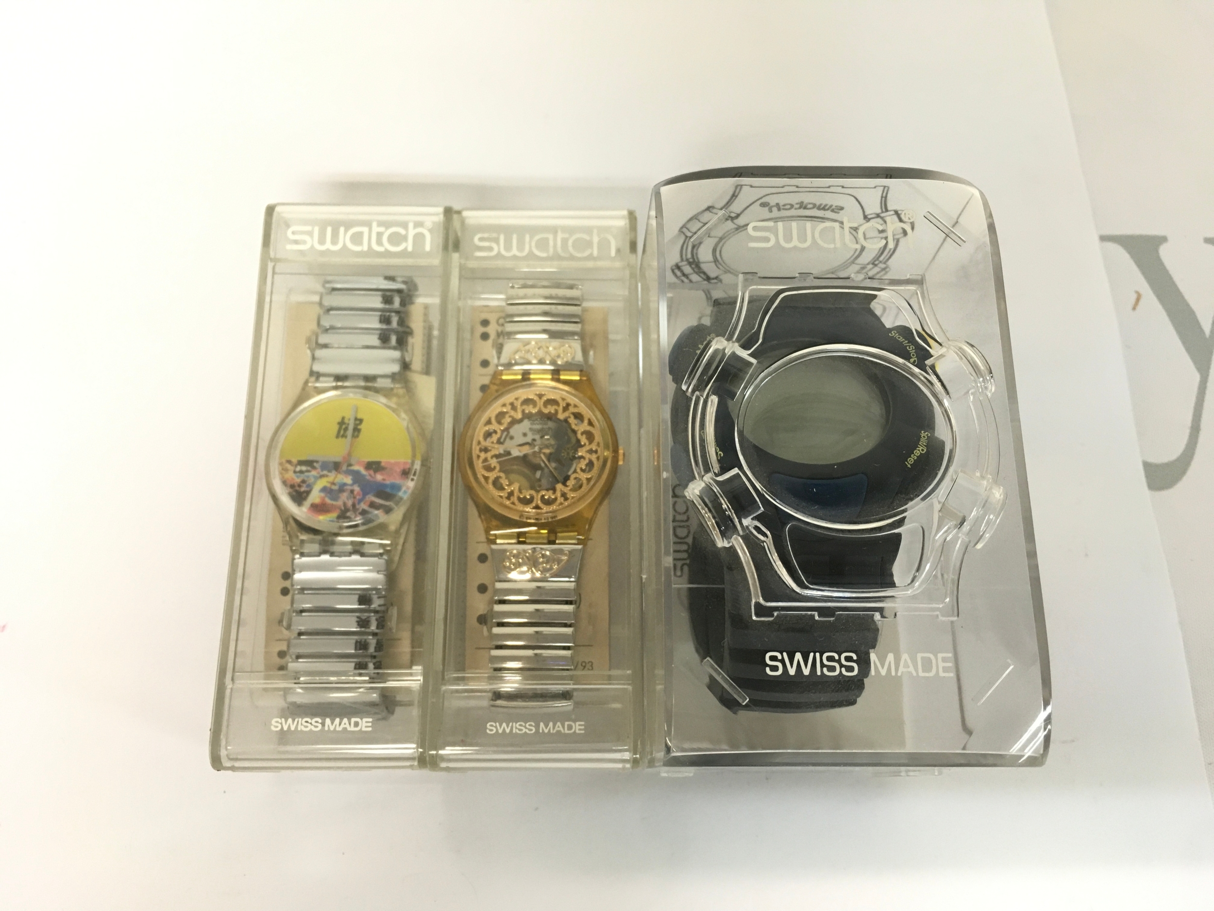 Collection of three Swarch watches including Swatch .Beat digital watch, likely from the 1999 "Wave Tour" collection