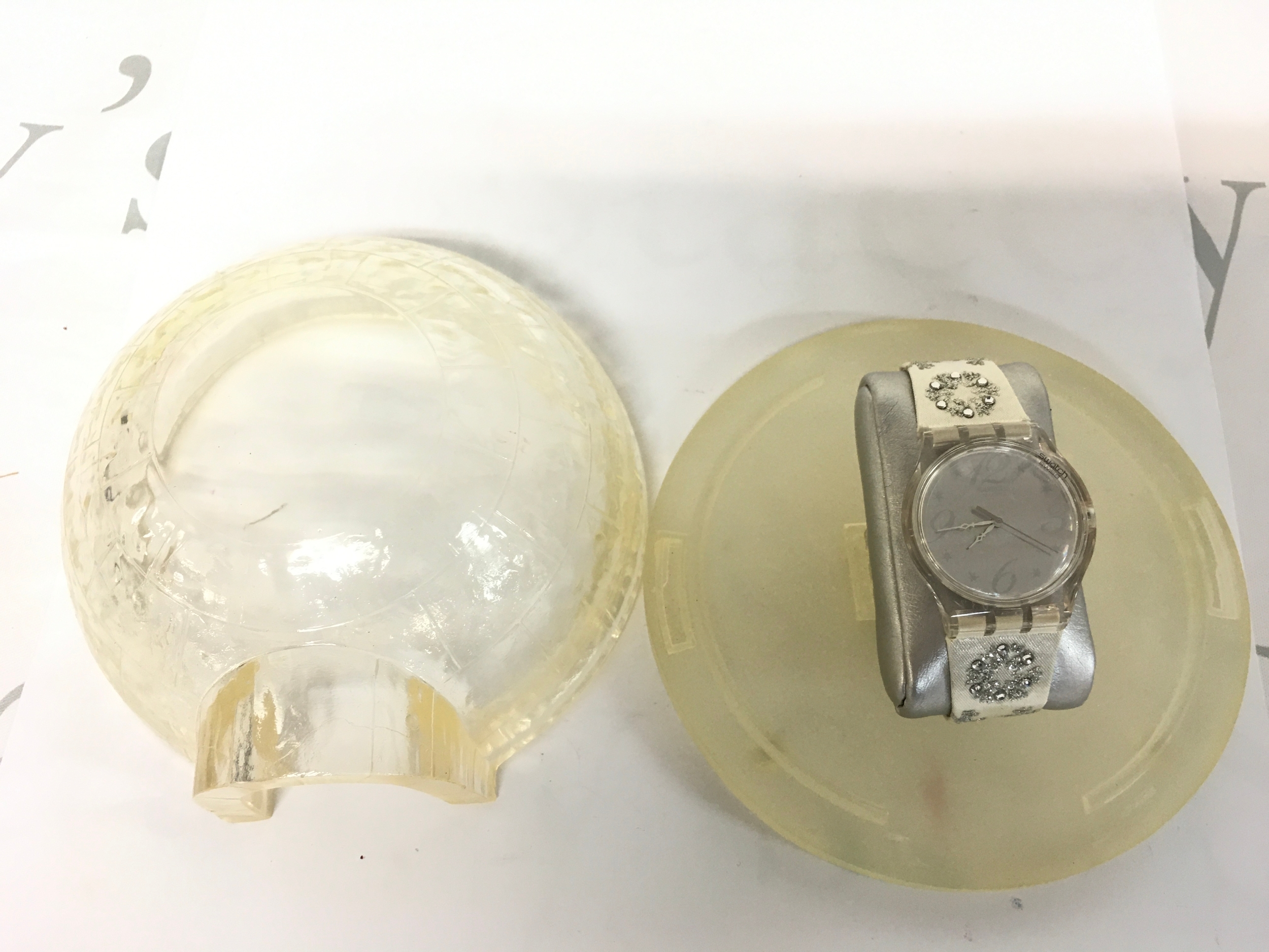 Swatch watch Arctic Touch (SUJZ100S) Christmas special from the 2000s, featuring a silver dial and a transparent case, comes with a decorative igloo-shaped container