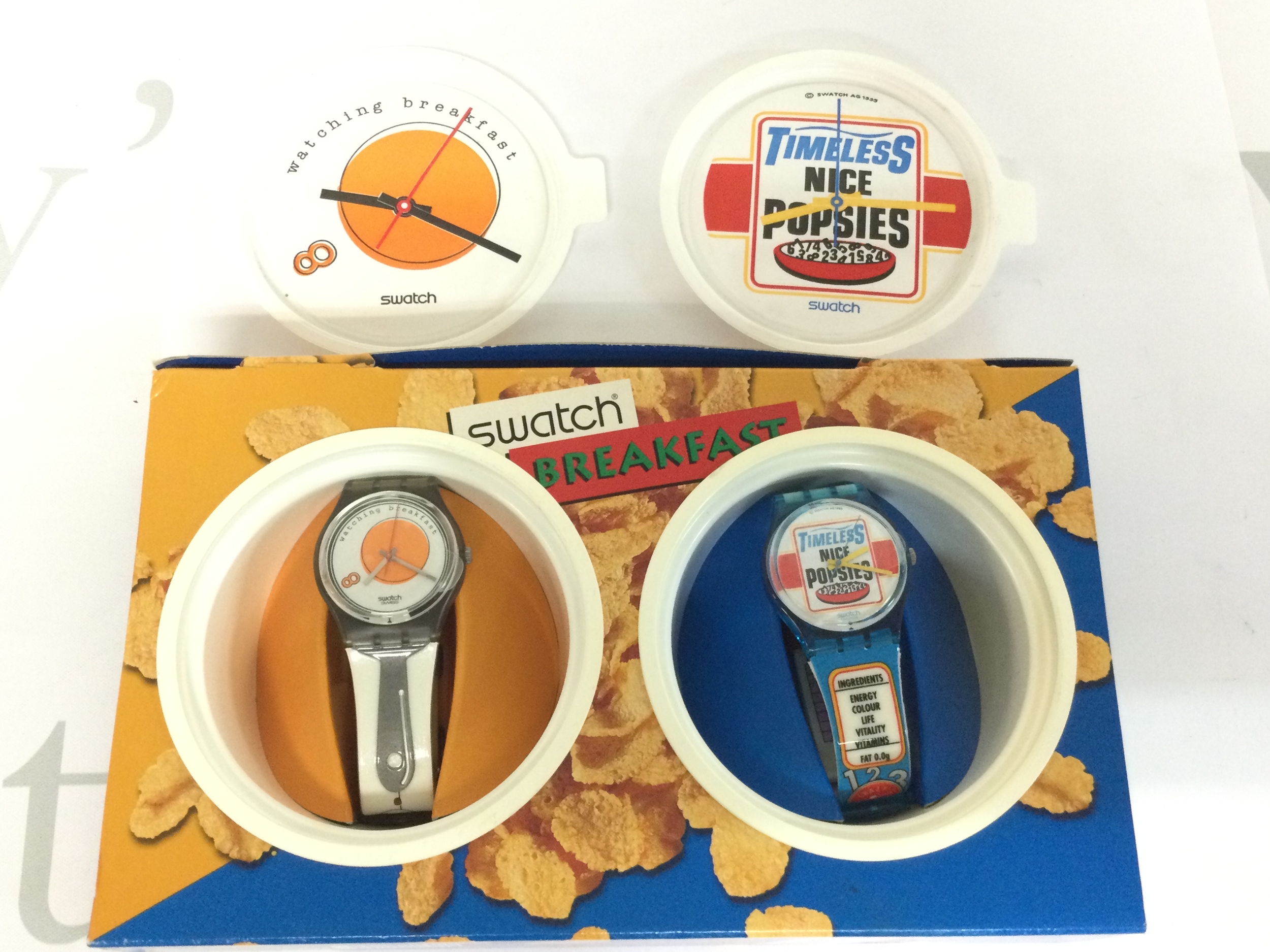 1995 swatch breakfast set including sunny side up and good morning. Comes with cereal box themed packaging.
