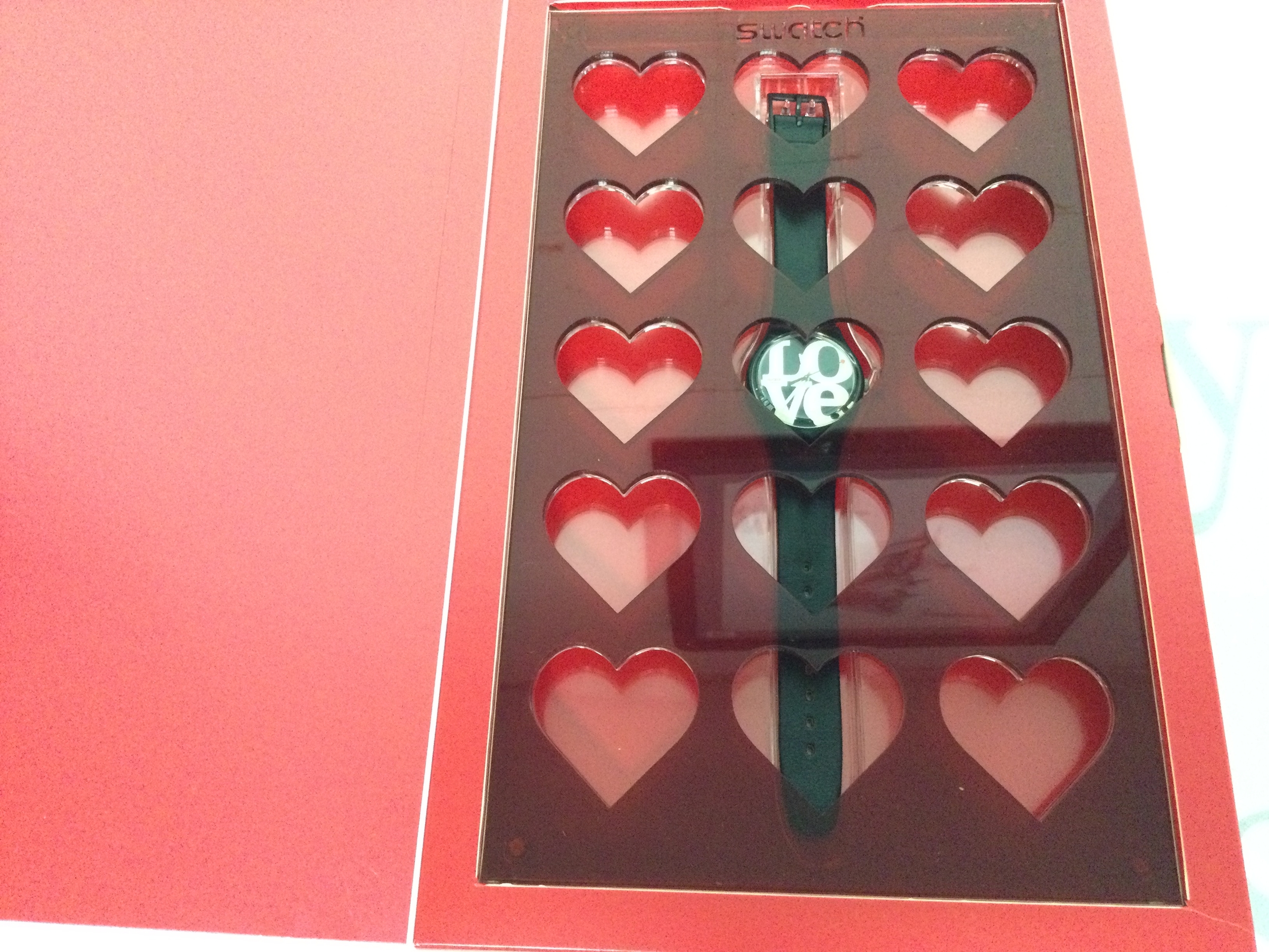 2004 Swatch enigmatic love watch with black leather strap dial designed with word love. Comes in red display case