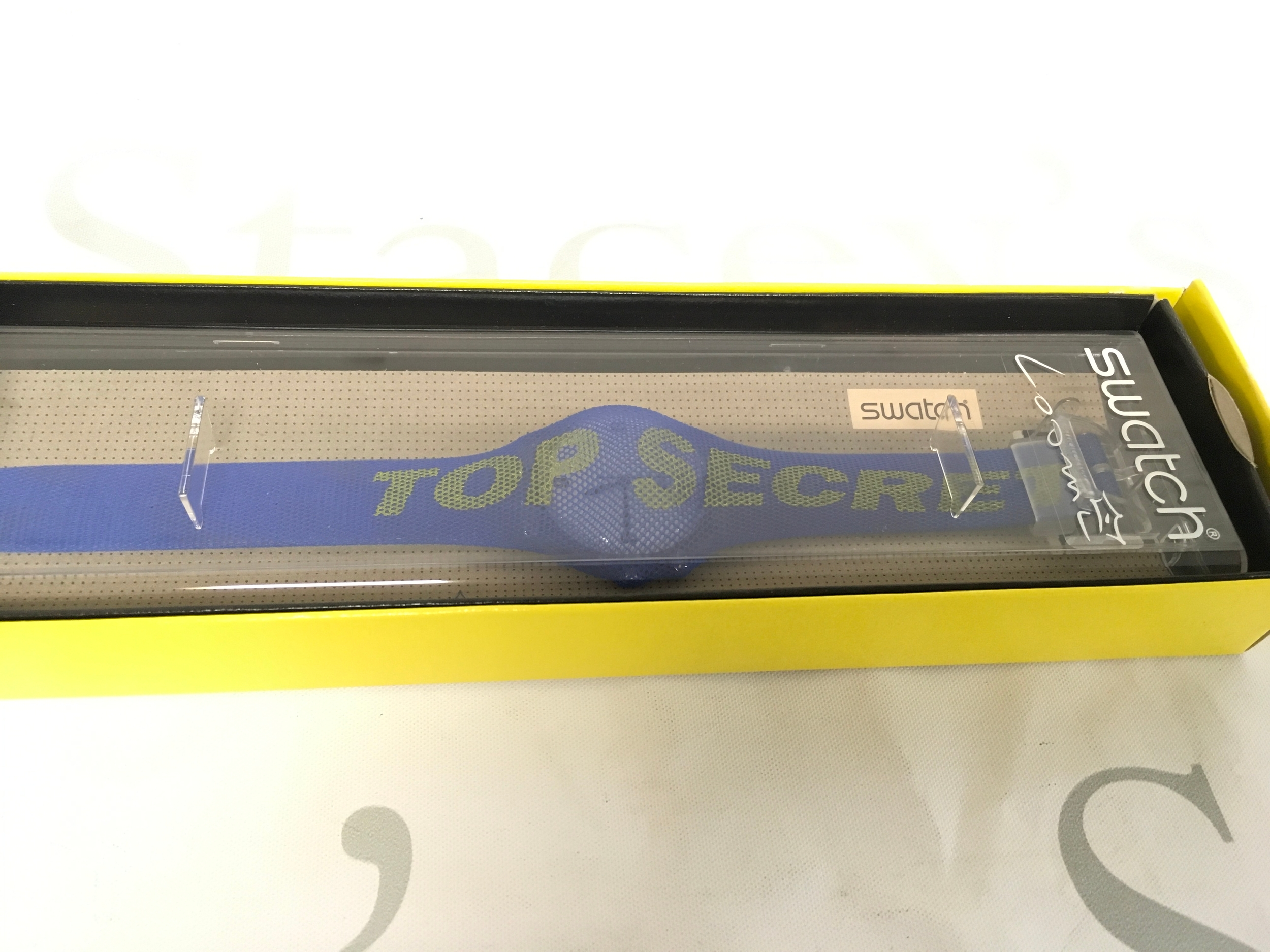 Swatch Top Secret (GK905) wristwatch from 1998, featuring a distinctive blue strap with yellow "TOP SECRET" text