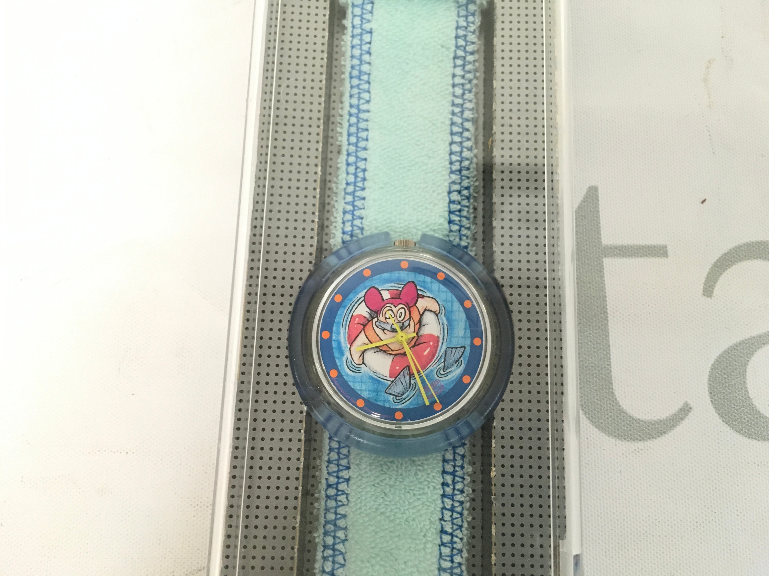 vintage 1996 Midi Pop Swatch "Bathing Beauty" (PMK113)featuring a character in a life preserver on the dial.