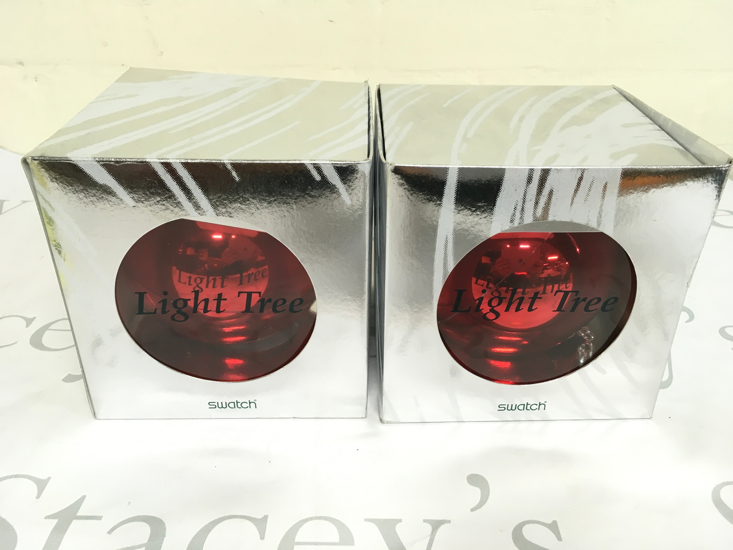 Two 1996 Swatch "Light Tree" Christmas Special (model GZ152), a limited edition set housed in a red ornament-shaped case. Only 20,000 units of this specific model were released worldwide. Comes with packaging.