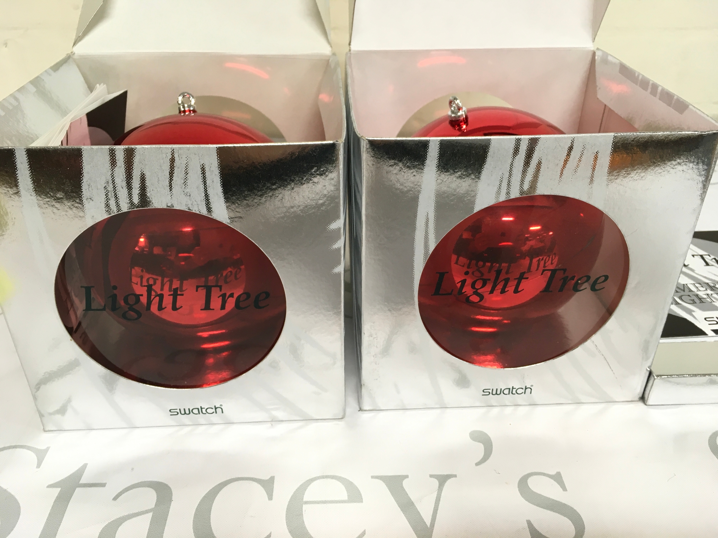 Two 1996 Swatch "Light Tree" Christmas Special (model GZ152), a limited edition set housed in a red ornament-shaped case. Only 20,000 units of this specific model were released worldwide. 