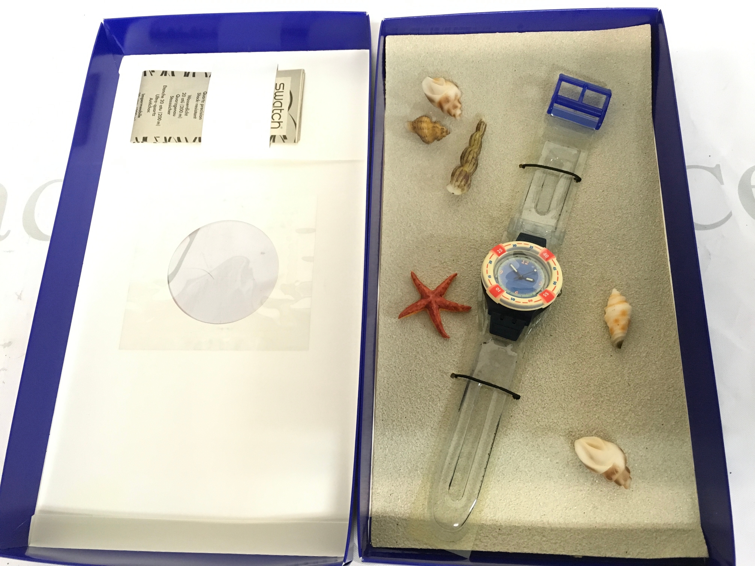 vintage 1999 Swatch Scuba 200 "Rescue" (SDN904) watch features a bezel designed like a life ring and a clear strap