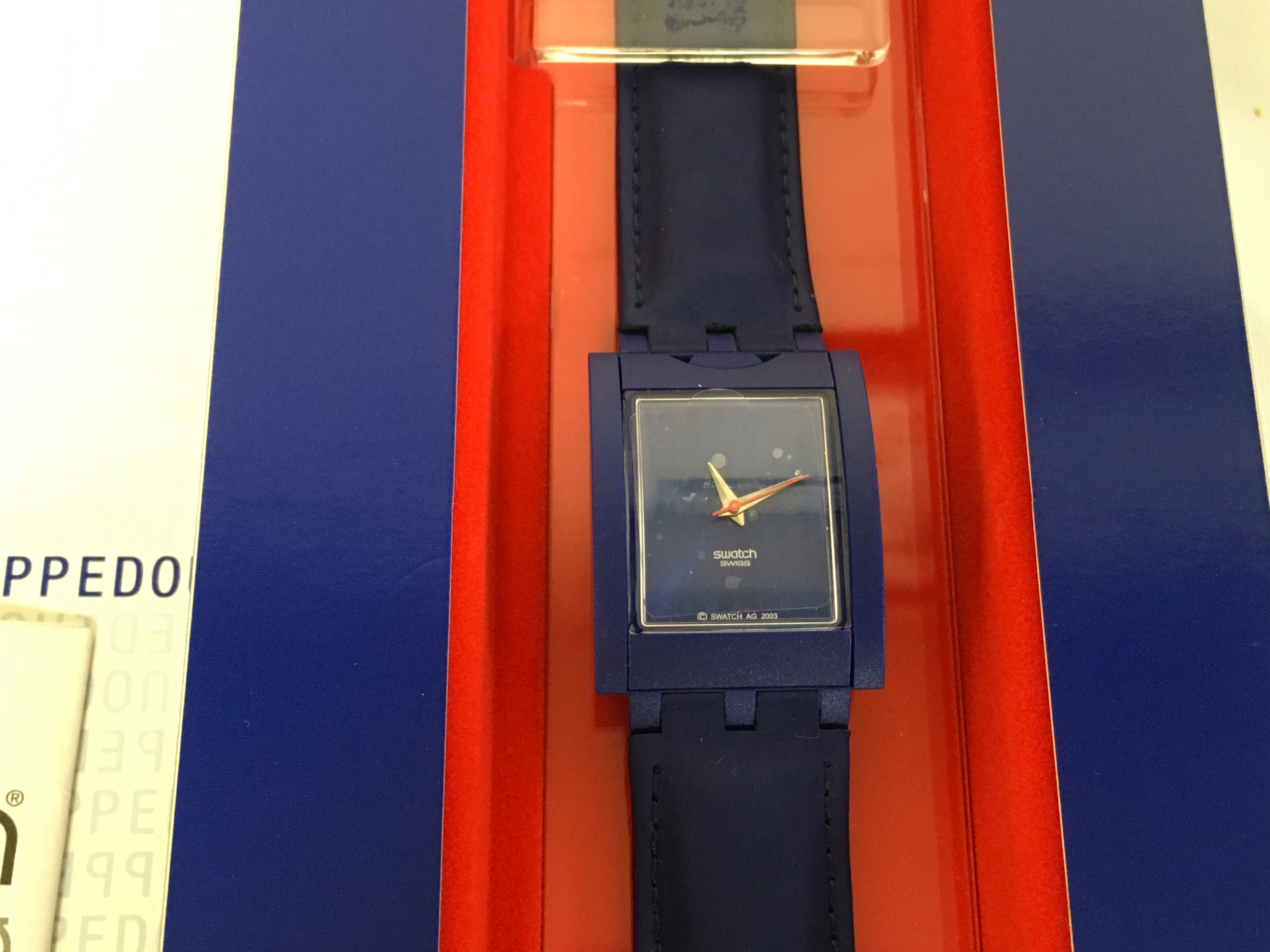 Swatch Flipped Out (SUFZ101) is a 2003 club special wristwatch presented in a specialised blue display box.