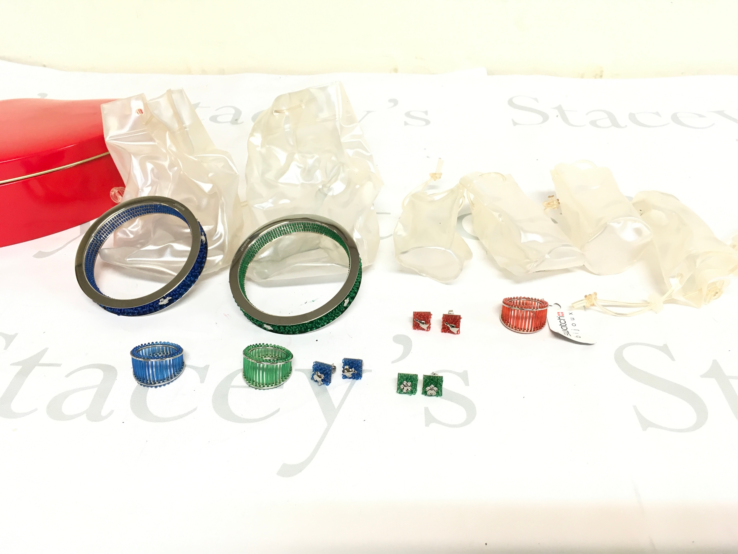 Collection of assorted swatch bijoux items including earrings rings etc