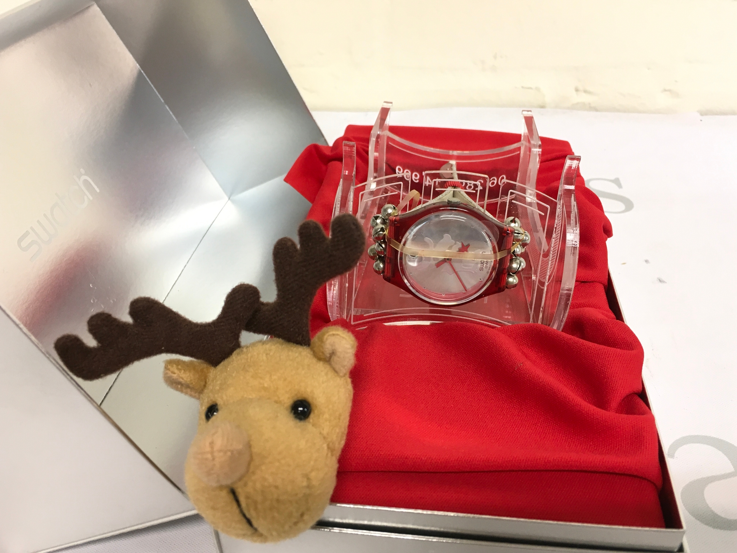 Swatch Gent Special "Jingle Jangle" (GZ408S) released for Christmas in 2003. The limited edition watch features a red translucent plastic case and a special reindeer-themed strap. It comes in a silver-colored metallic box with a plush reindeer head decoration. Only 14,999 pieces of this holiday special were produced