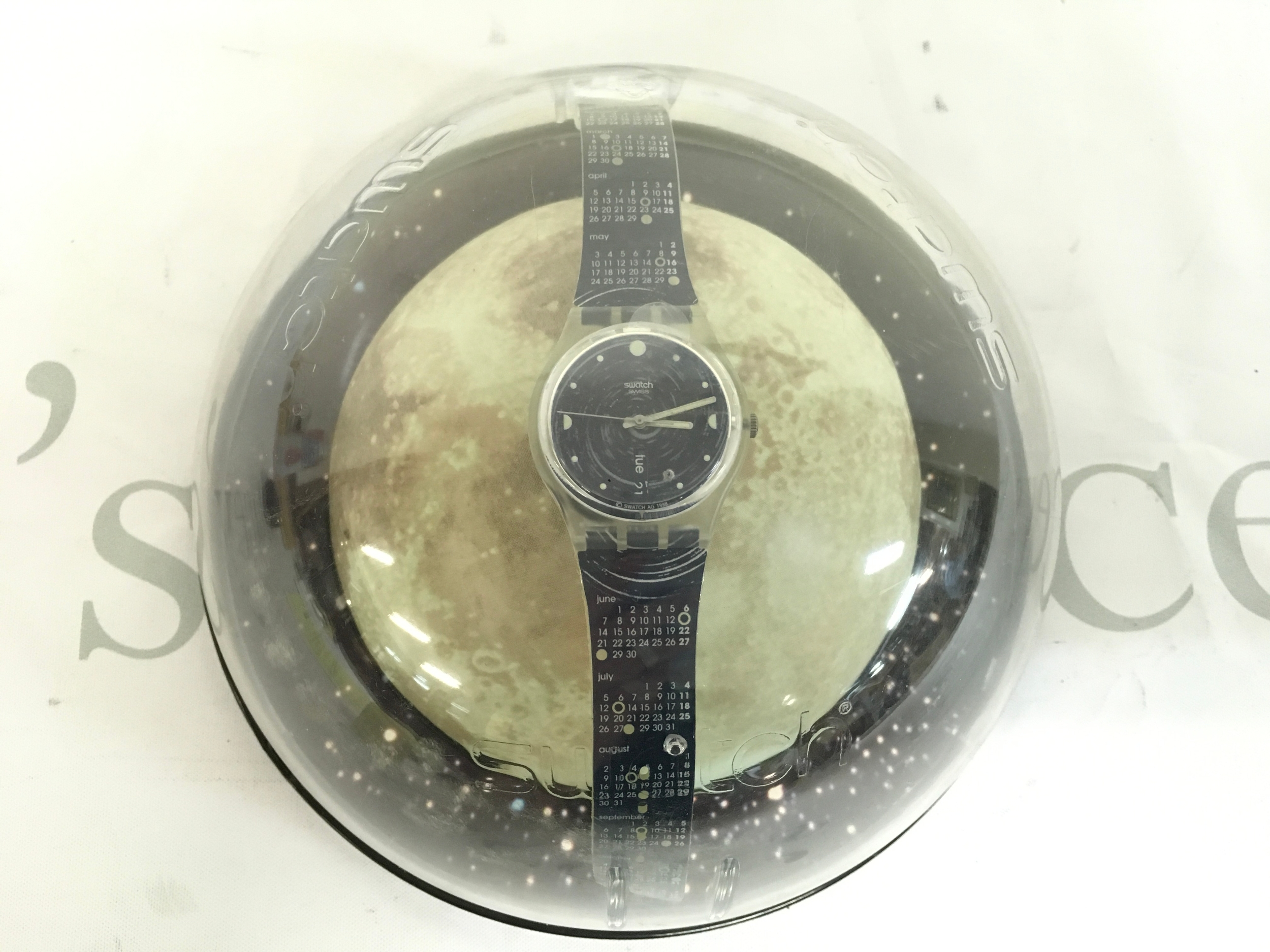 1999 Swatch Artists Series "It's Coming" (GN712) watchfeaturing a calendar strap and special dome packaging