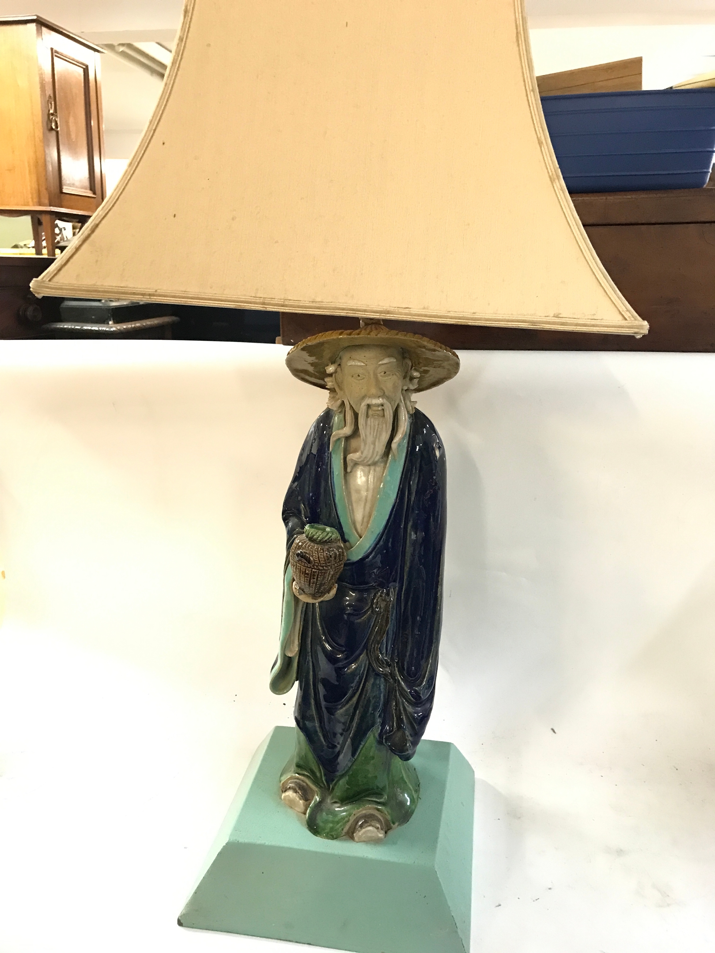 Chinese Shiwan (Shekwan) pottery mudman figurine lamp features a glazed sage or fisherman wearing a traditional straw hat and carrying a basket., 72cm tall 