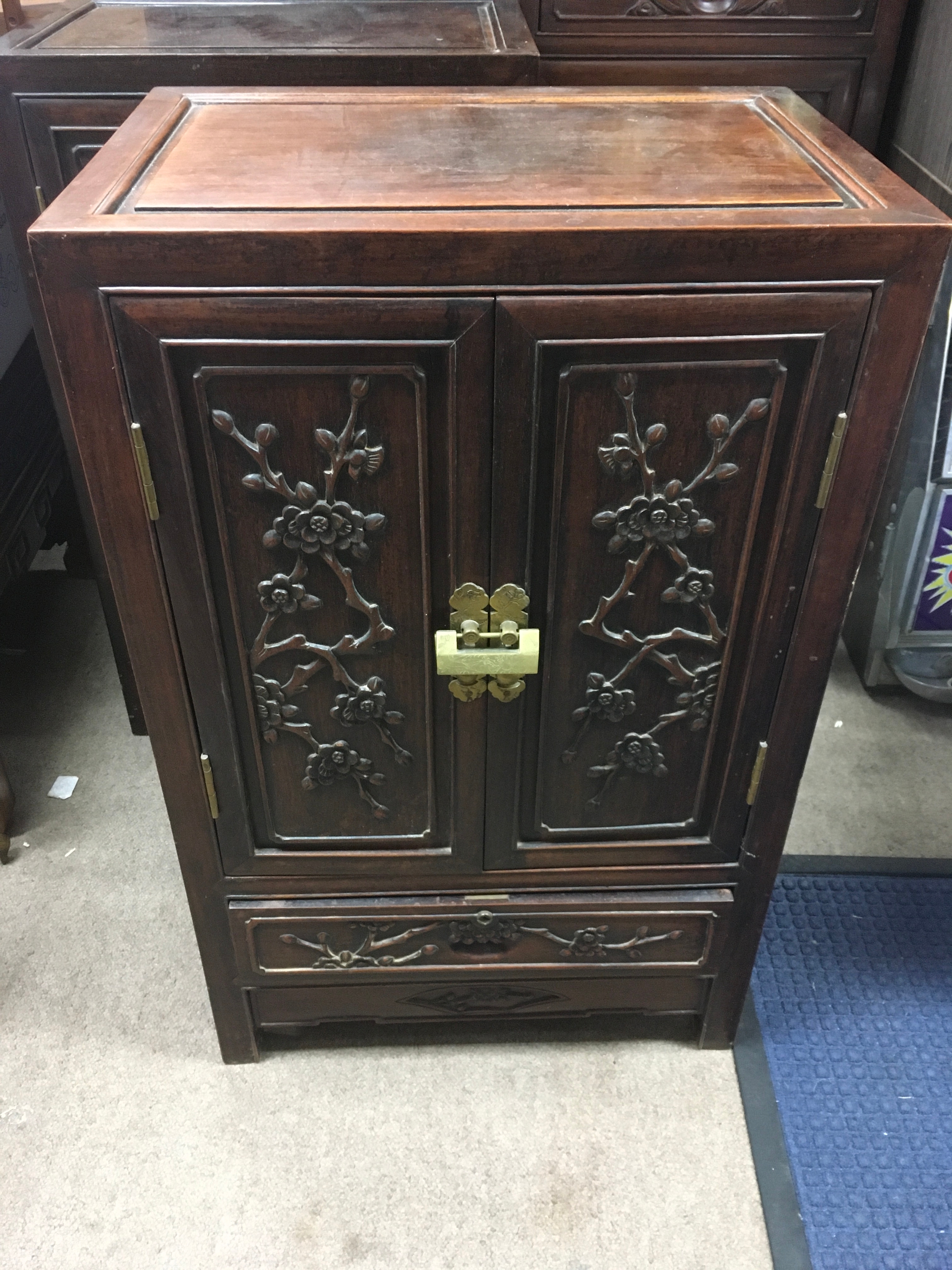 Three vintage Chinese hardwood cabinets featuring carved floral patterns. Height 81cm, Width 51cm. Height 91cm, Width 91cm. 