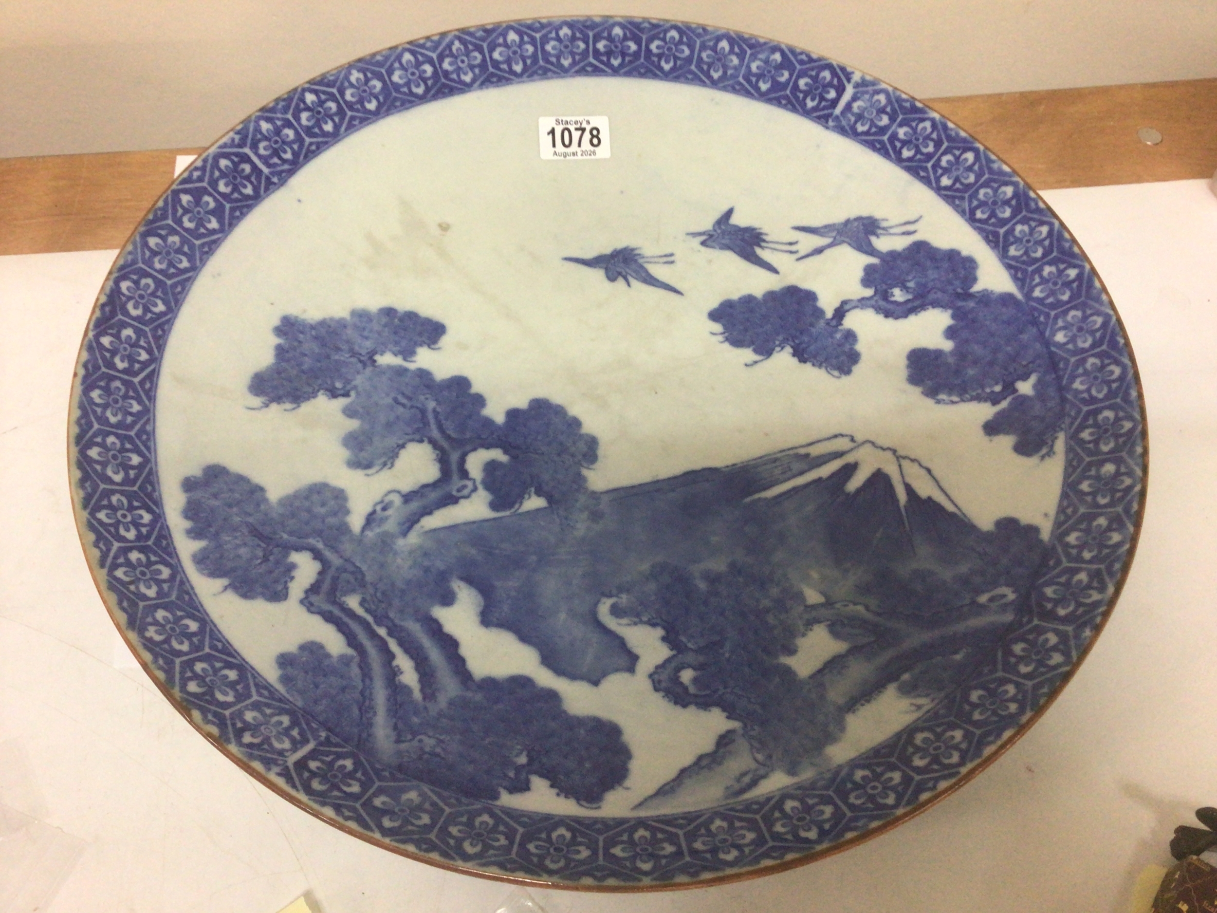  A Japanese blue and white wall charger depicting Mount Fuji with birds and foliage diameter 45cm no obvious damage 