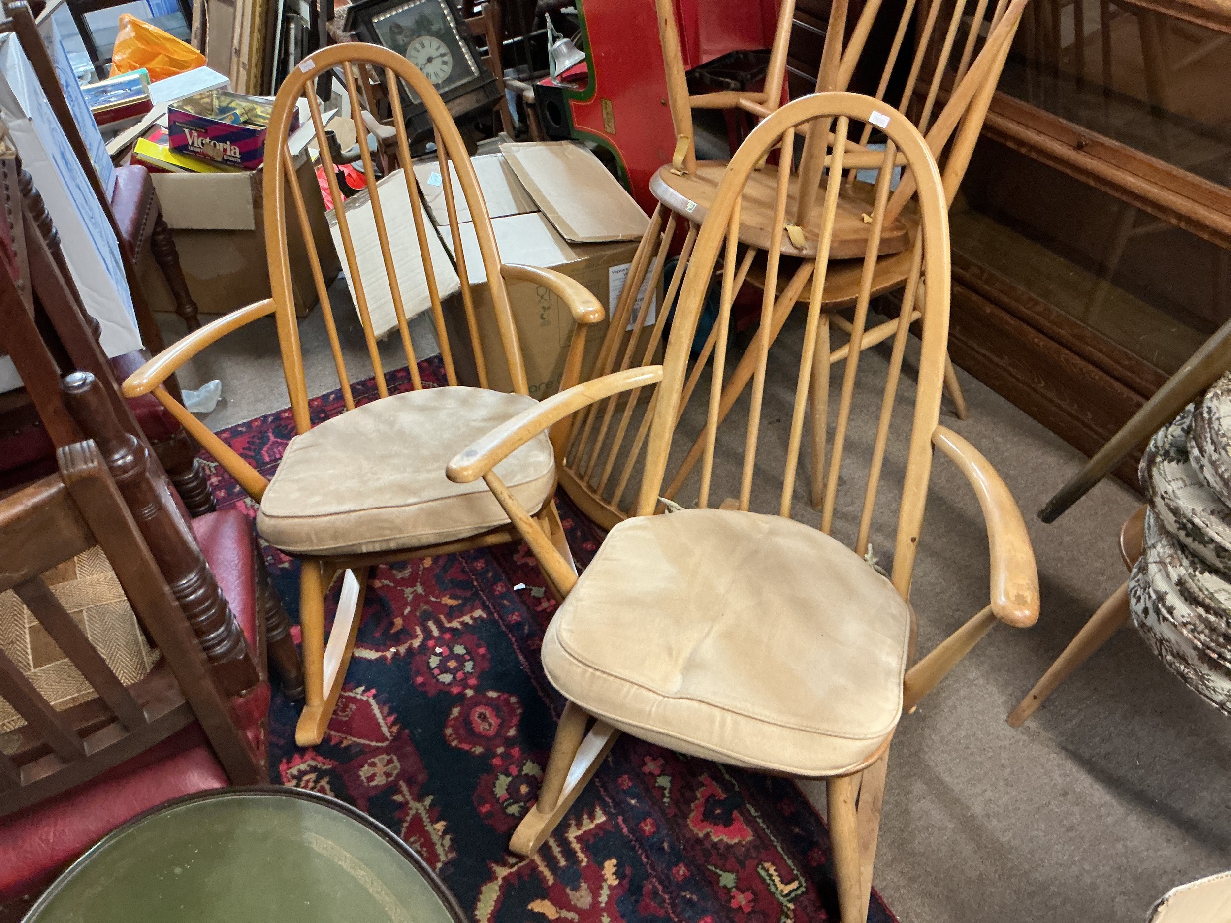A pair of blonde Ercol rocking chairs.