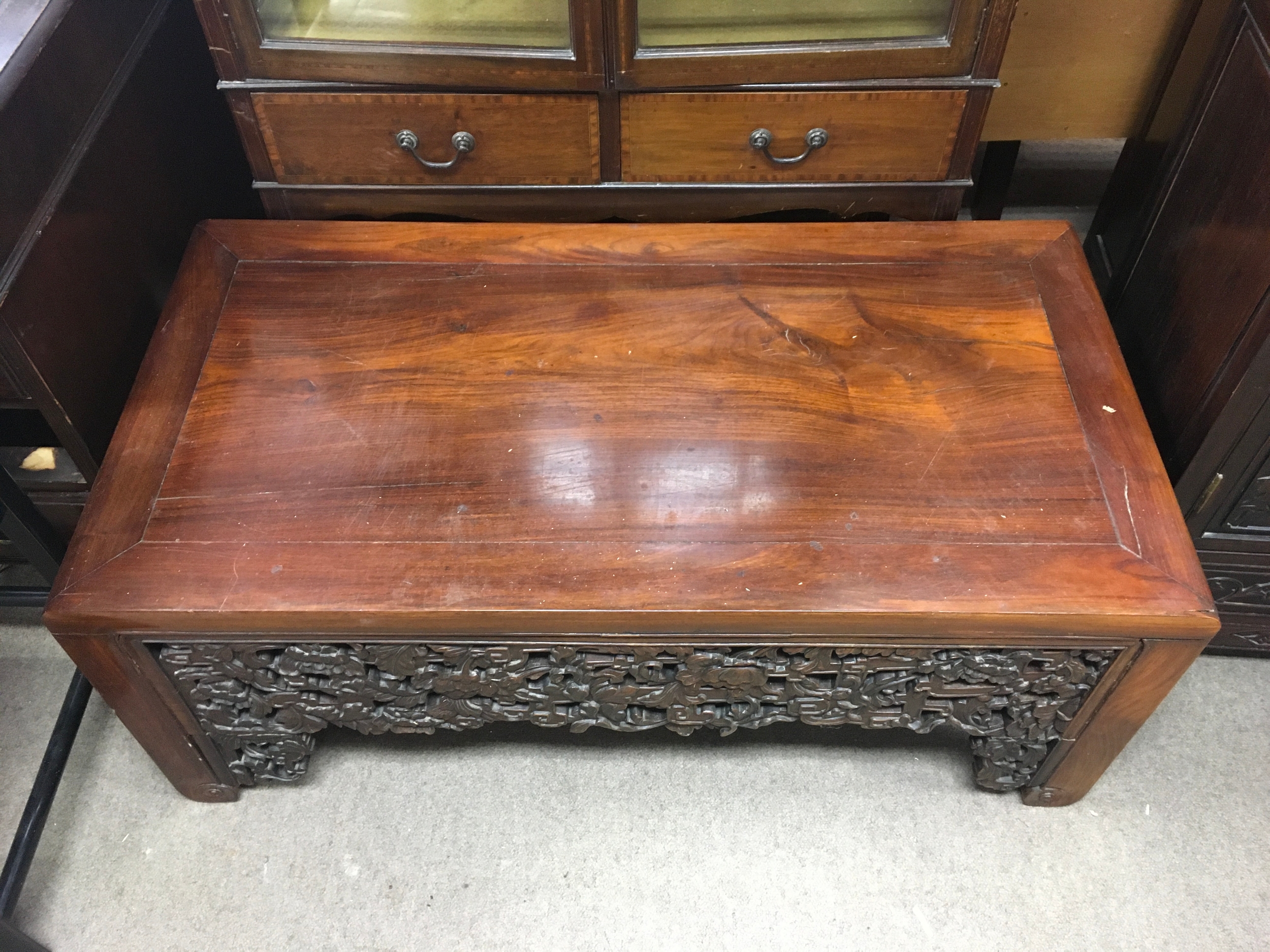 A Chinese 19th century hardwood table. Height 46cm, Width 114cm.