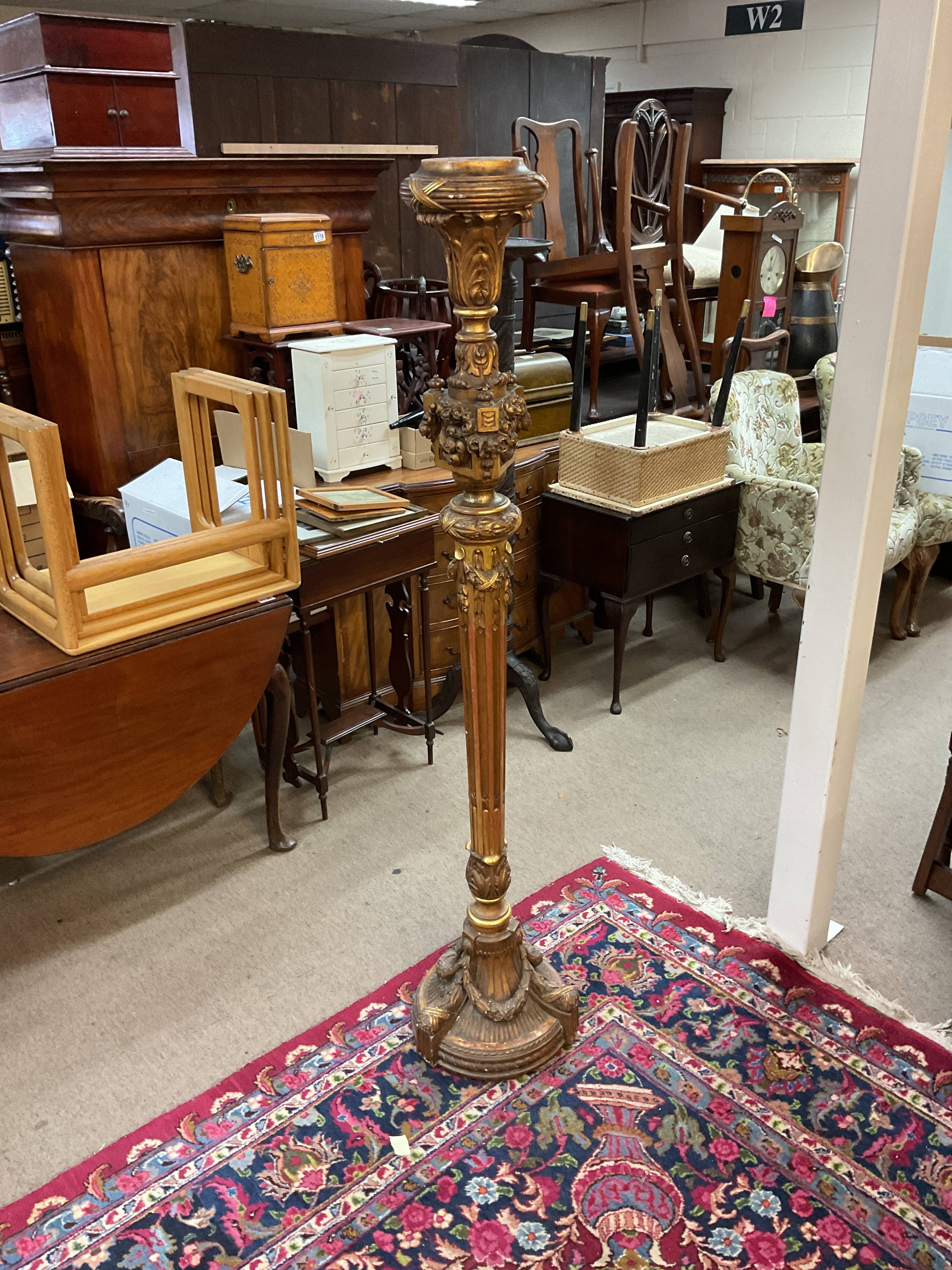 19th C gilt wood Torchiere, circular metal weighted base, with three garland swags moving up a fluted baluster stem then decorated with further garlands and Acanthus leaves. H161 cm.