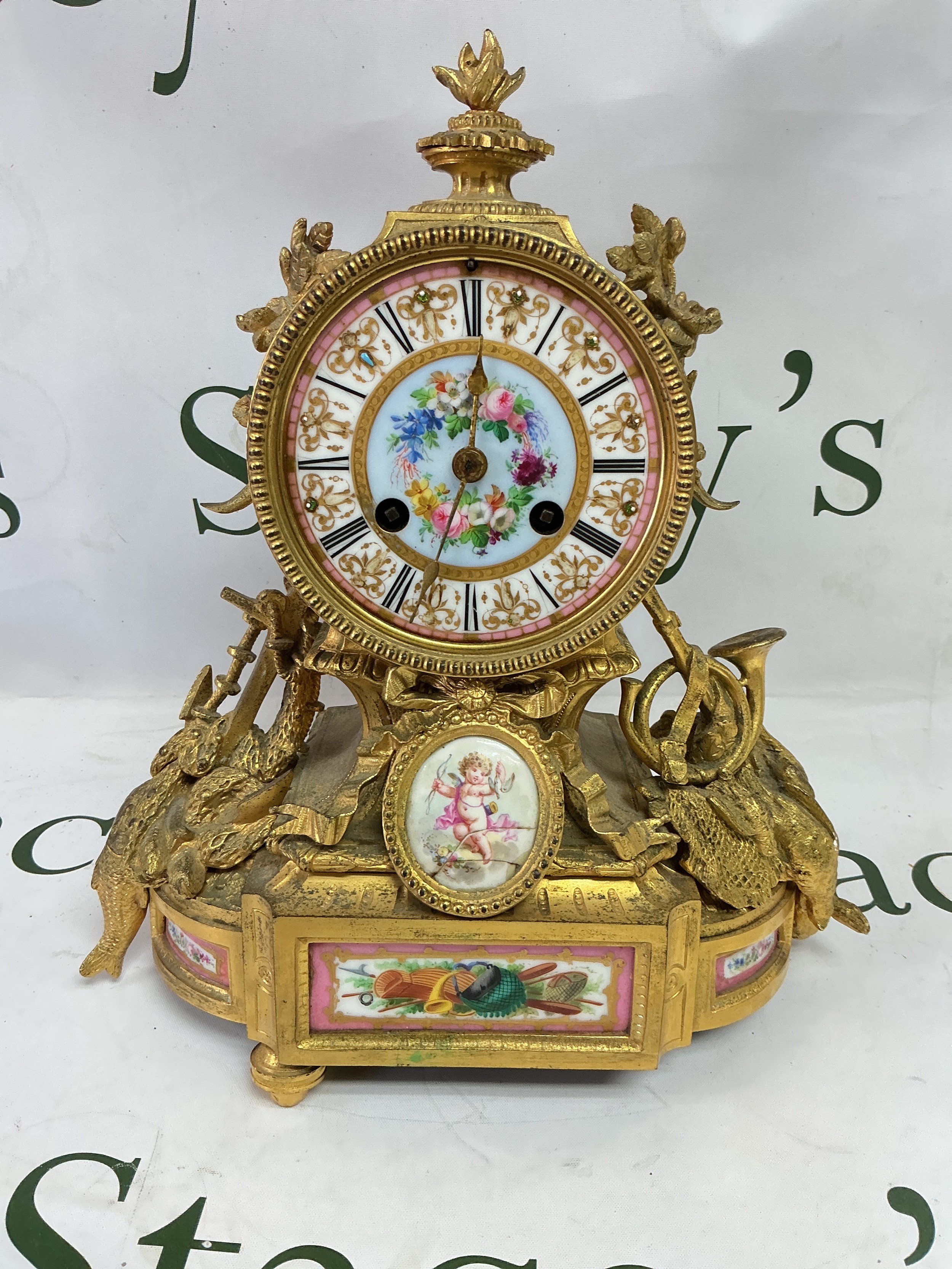 A French giltwork mantle clock with painted enamel dial, a/f. Approx height 30cm.
