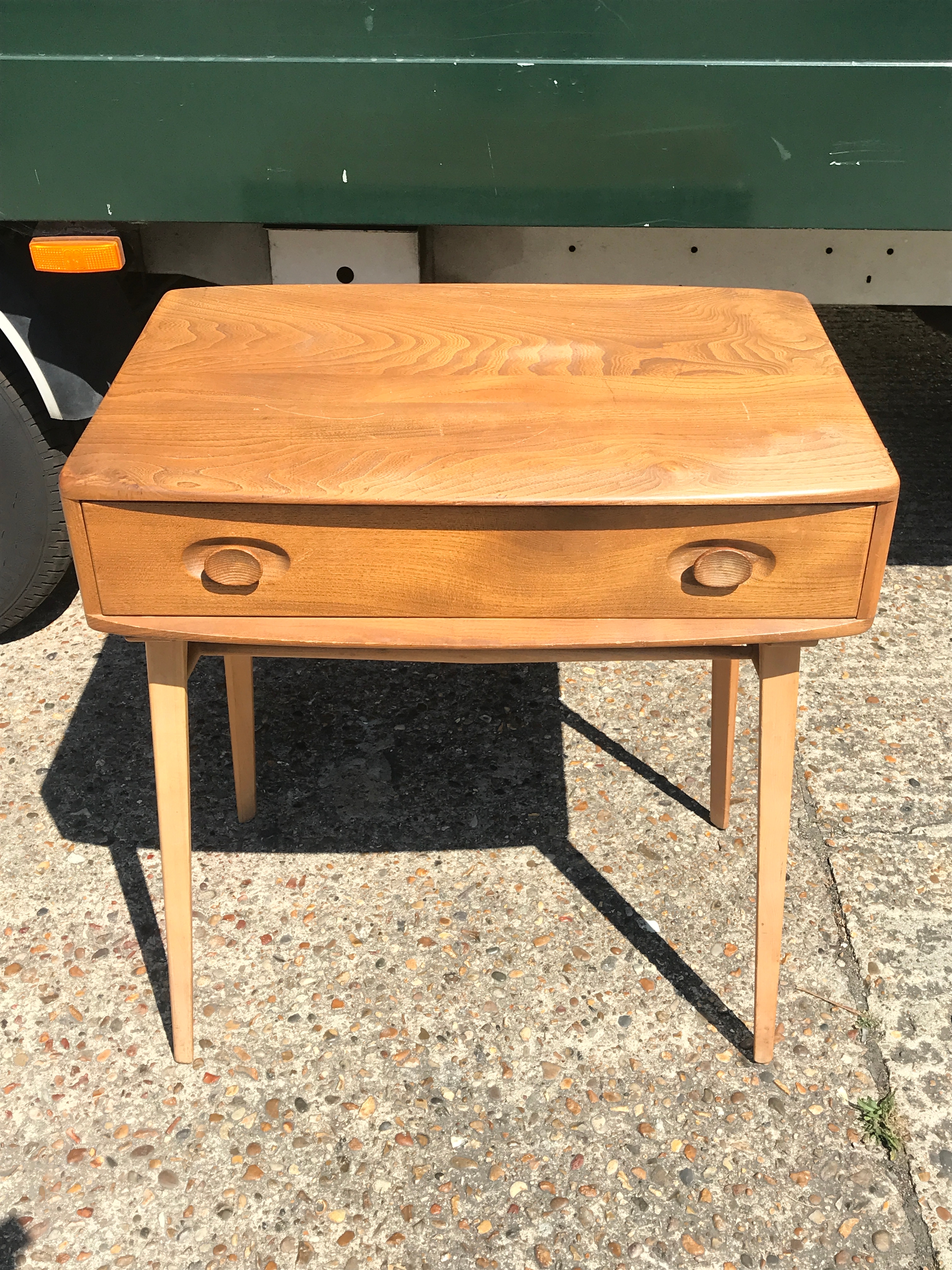 A modern Ercol side table with a single drawer, dimensions 48x68x74cm