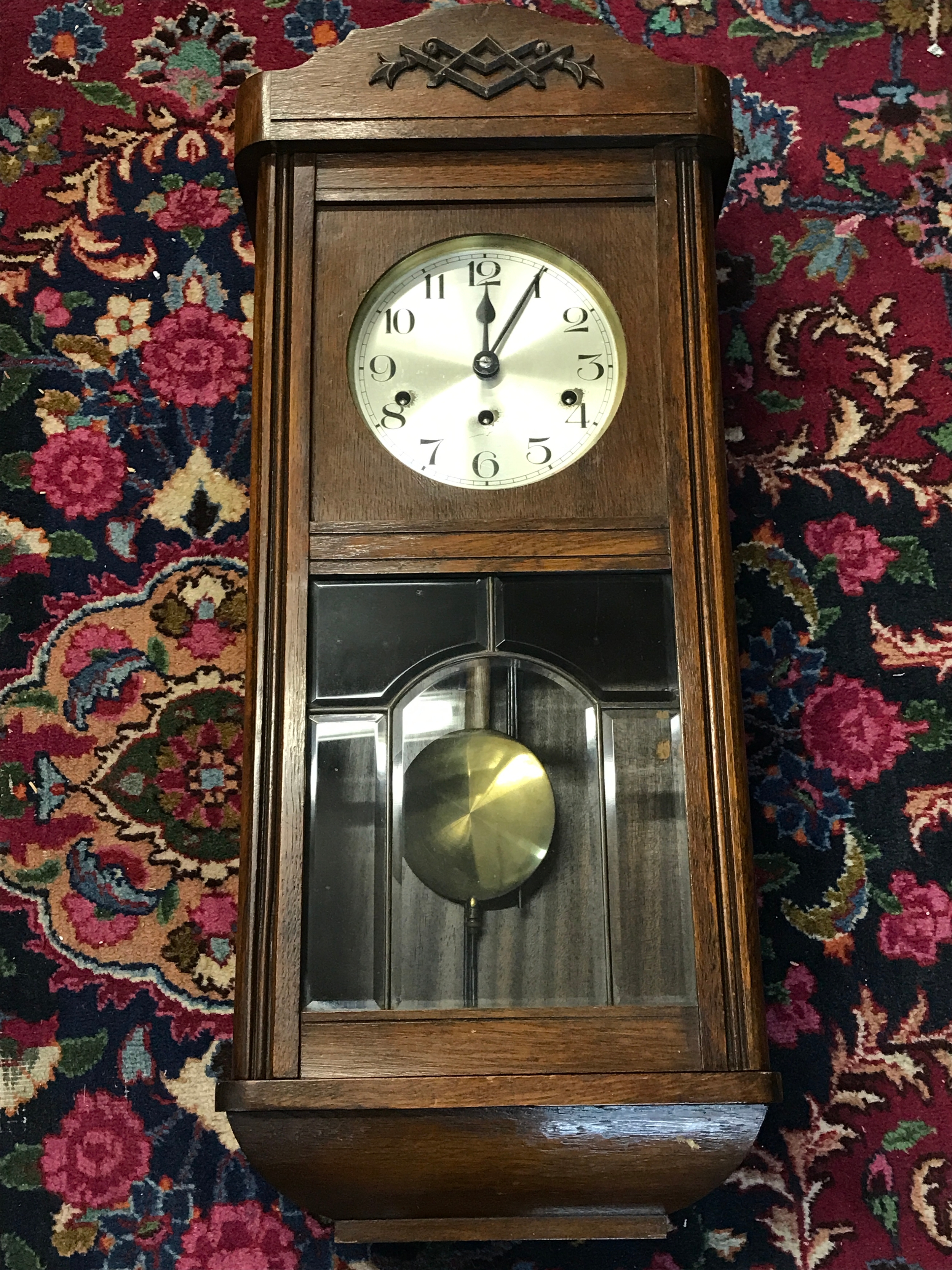 An oak cased wall clock 78cm tall, 30cm wide, 16cm long. With key