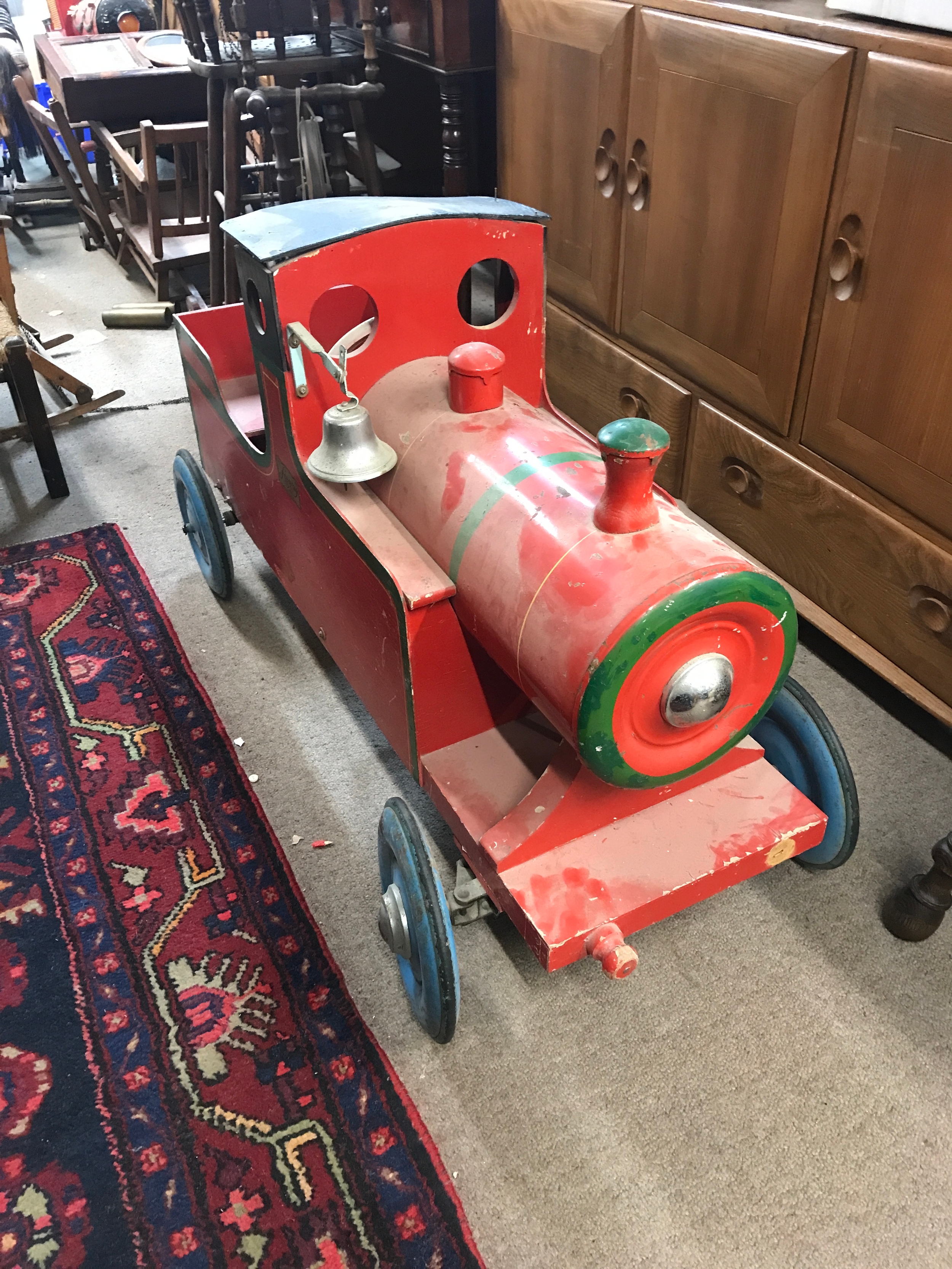 A vintage children's train pedal car . 107cm long, 61cm tall