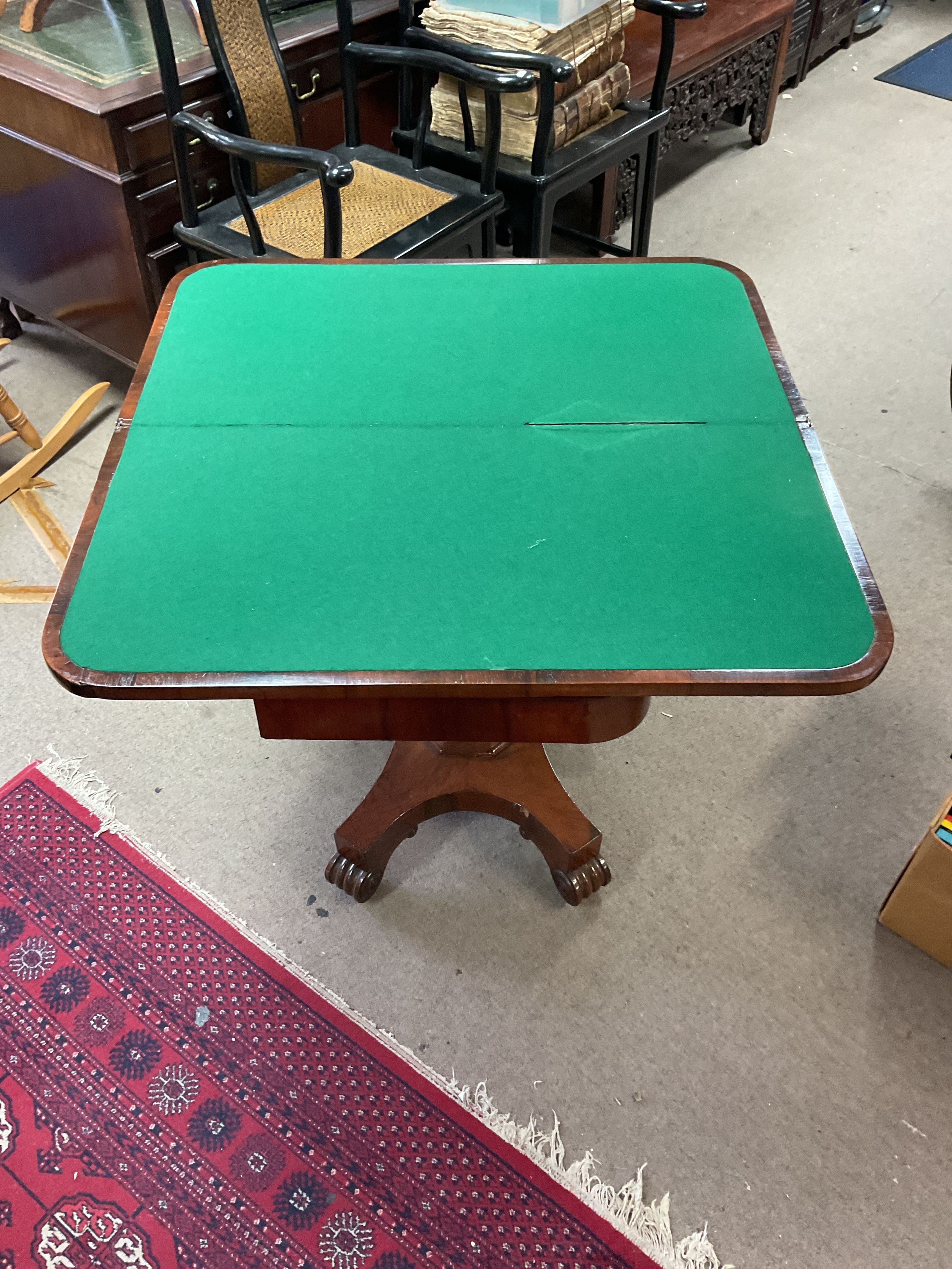 Late 19th C mahogany card table on octagonal pedestal terminating in four scroll feet, H74 cm x W91 cm x D45 cm closed 91 cm open.