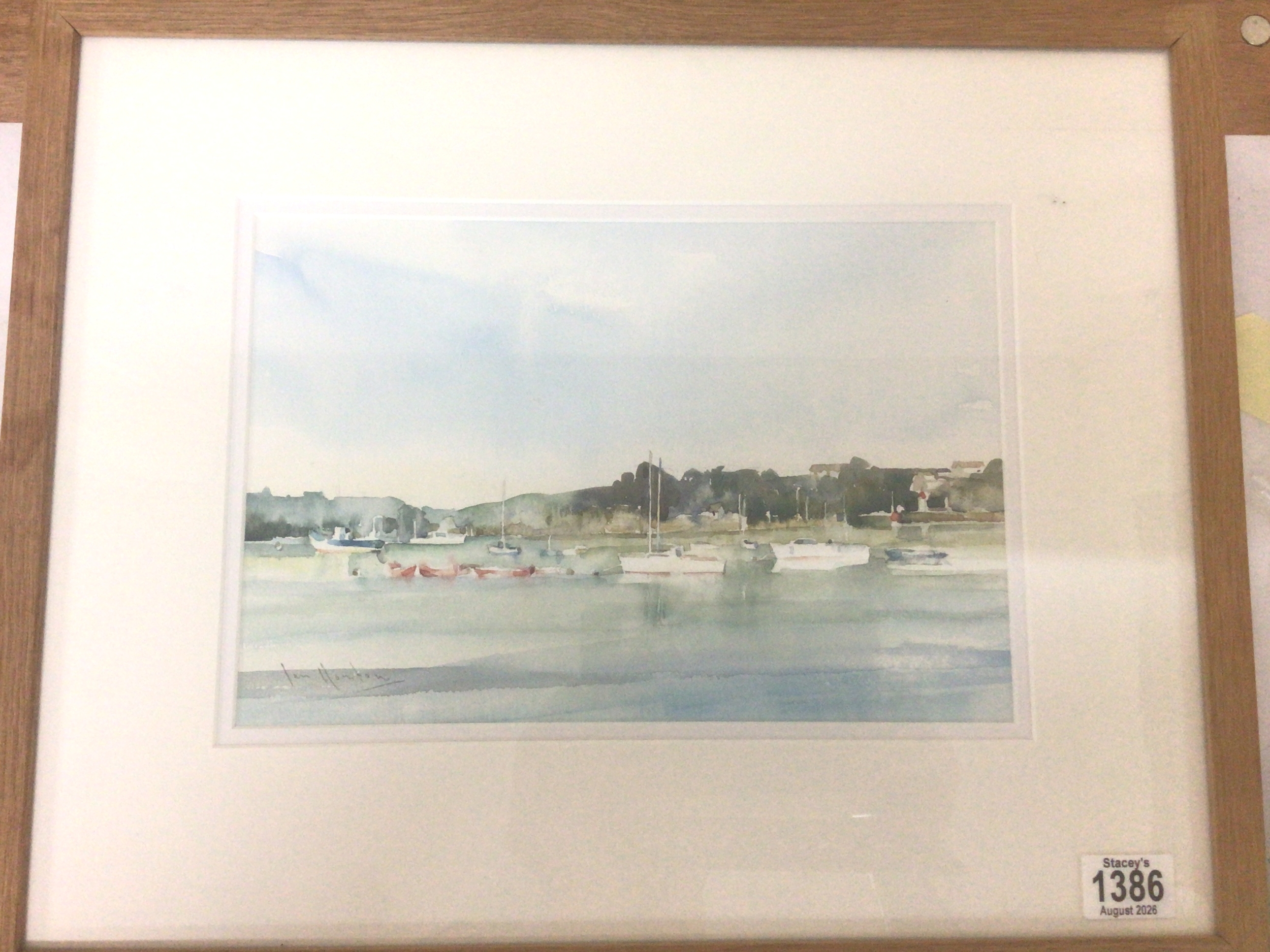  A framed watercolour entitled Moored Boats by Ian Houston b1934. The picture with gallery label exhibited in 2023 The Sadler Street Gallery.51cmx41cm 