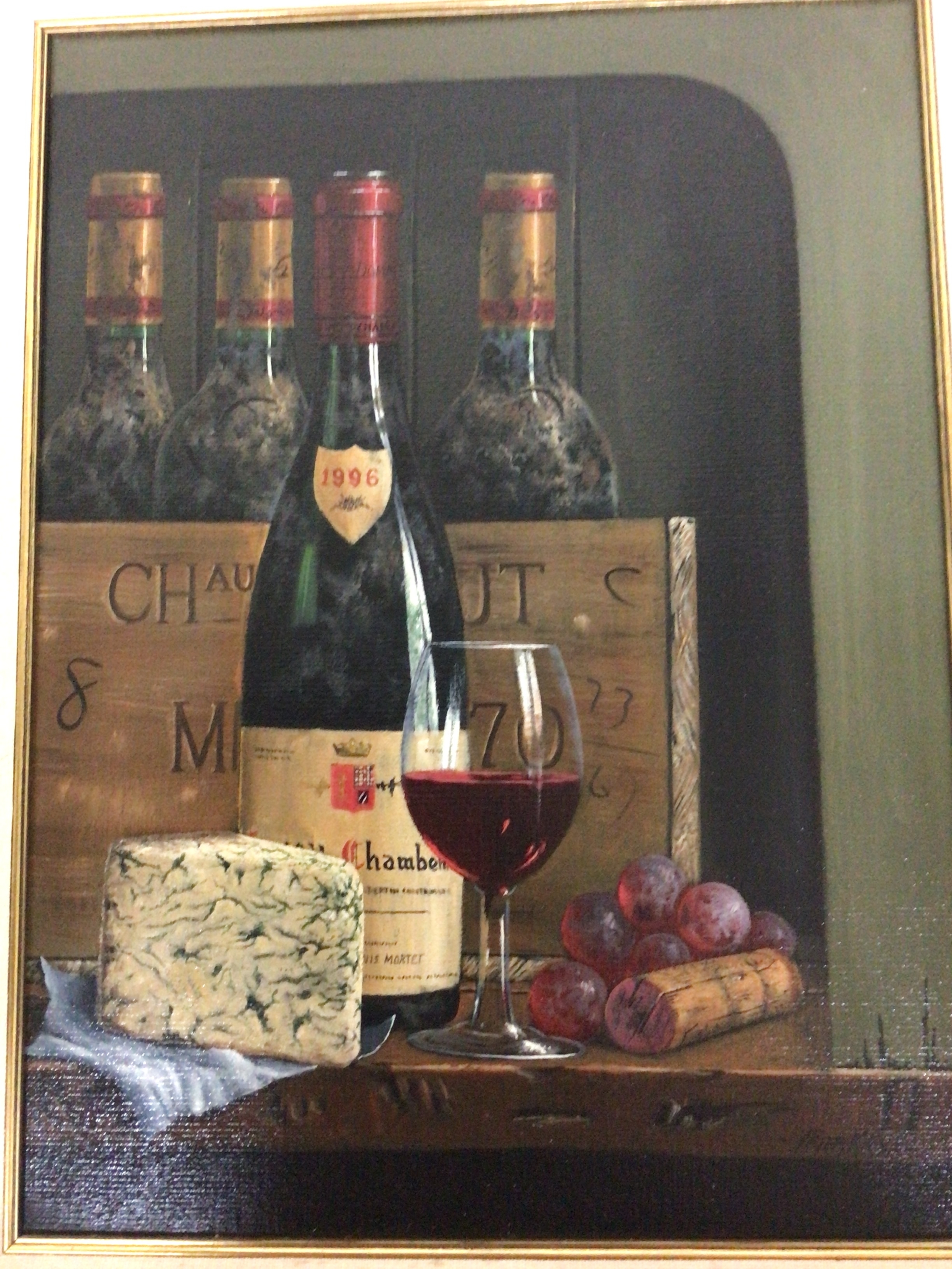  A framed Oil painting still life study of a case of quality wine on a table with cheese and grapes. Signed by the artist Peter Kotka. 42x53 