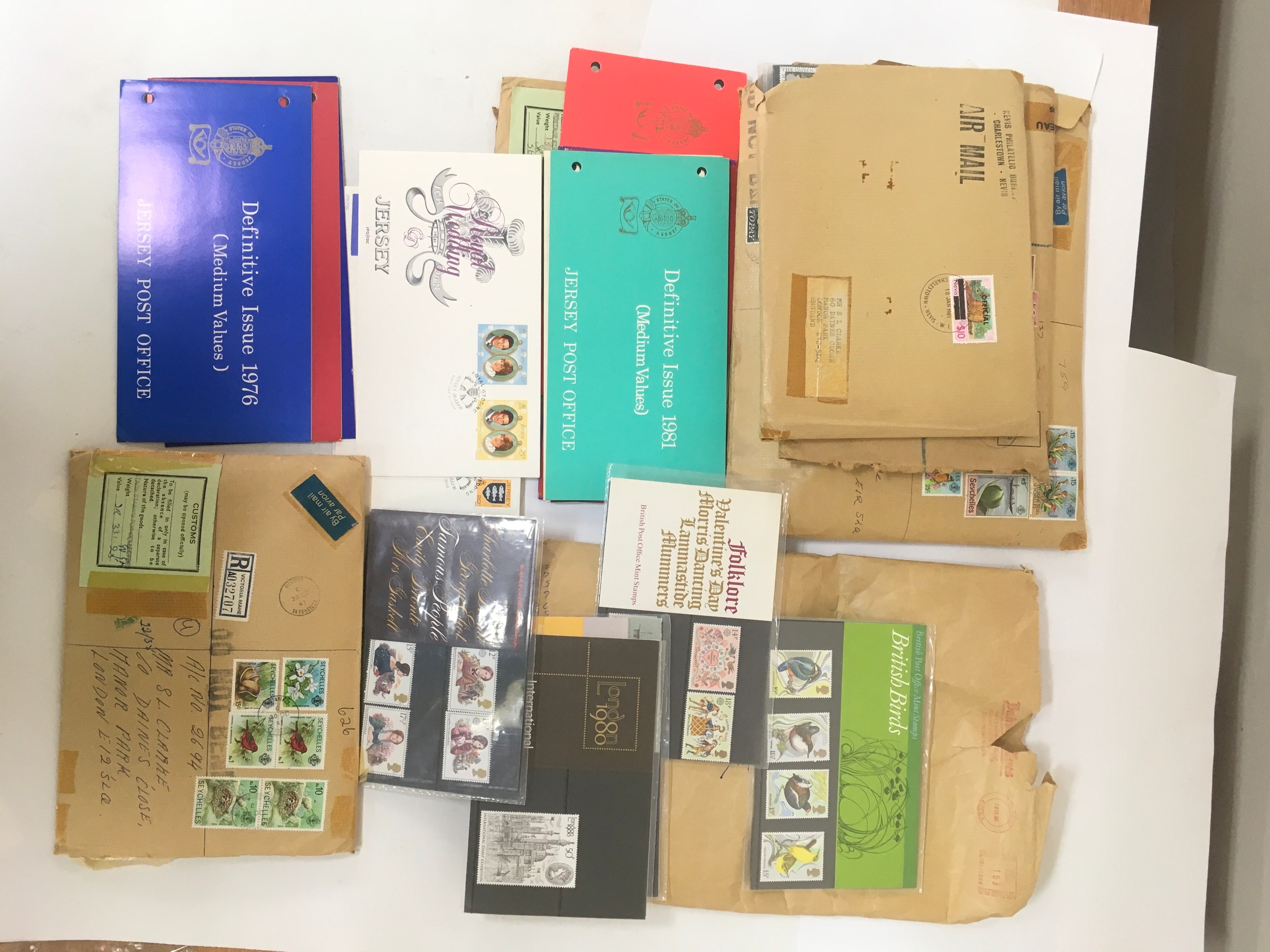  Assortment of Commemorative and channel island stamps used and unused. Collection also includes stamp leaflets and guides for specific stamps in the lot.