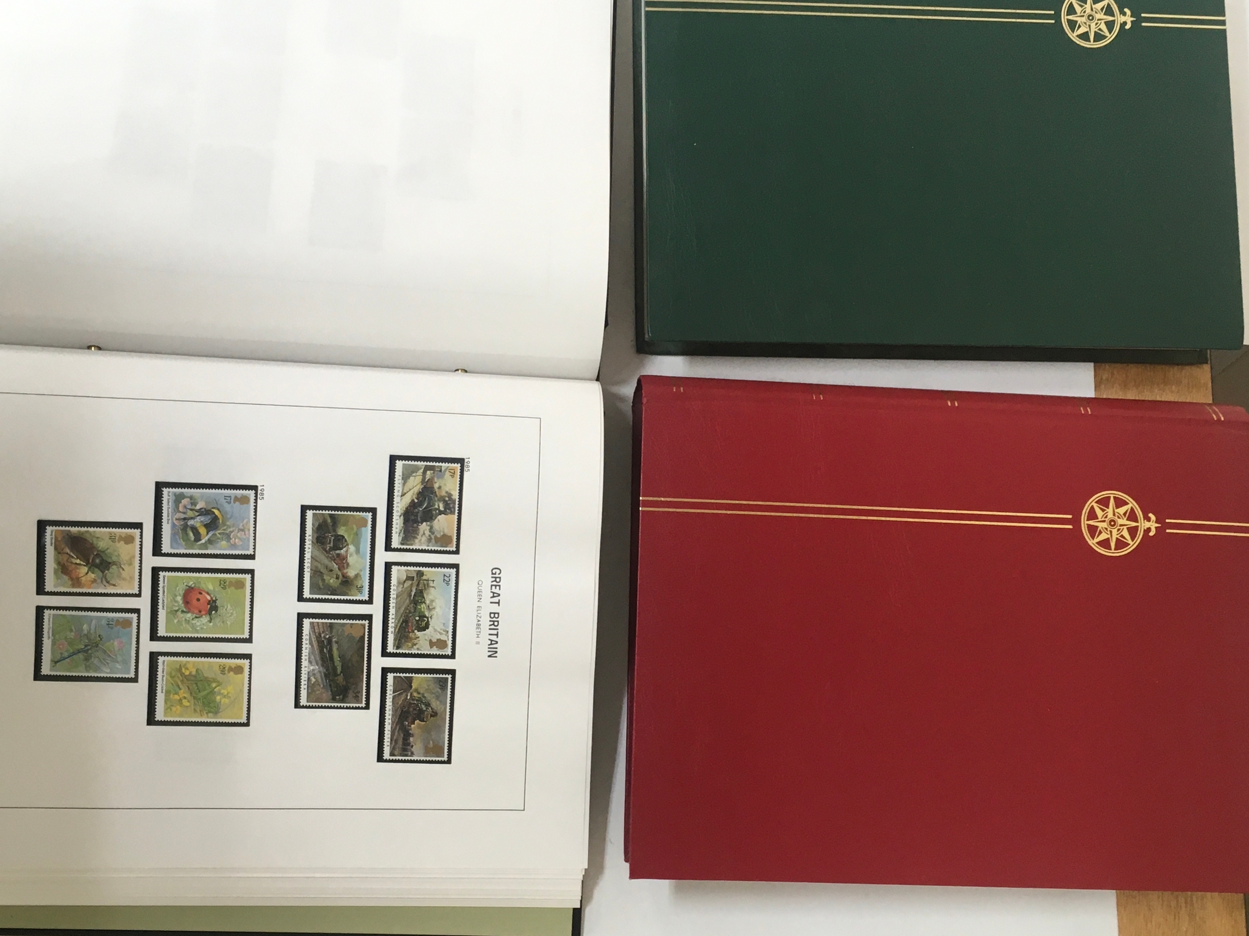 Collection of 5  mostly empty stamp albums including one from Stanley Gibbons. Mostly British and British commemorative stamps. Other stamps include international stamps both used and unused.