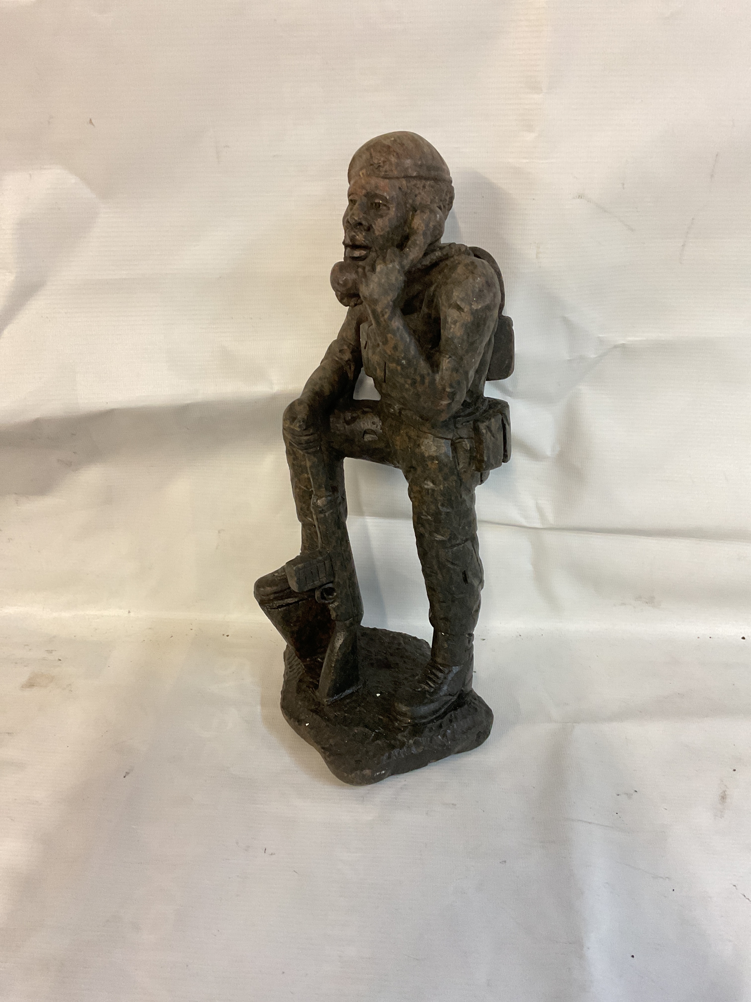 Large Rhodesian Soapstone Carving of a rifleman with radio and rifle and beret carved. 37 cm High. Cleverly carved from a stone resembling the camo pattern.