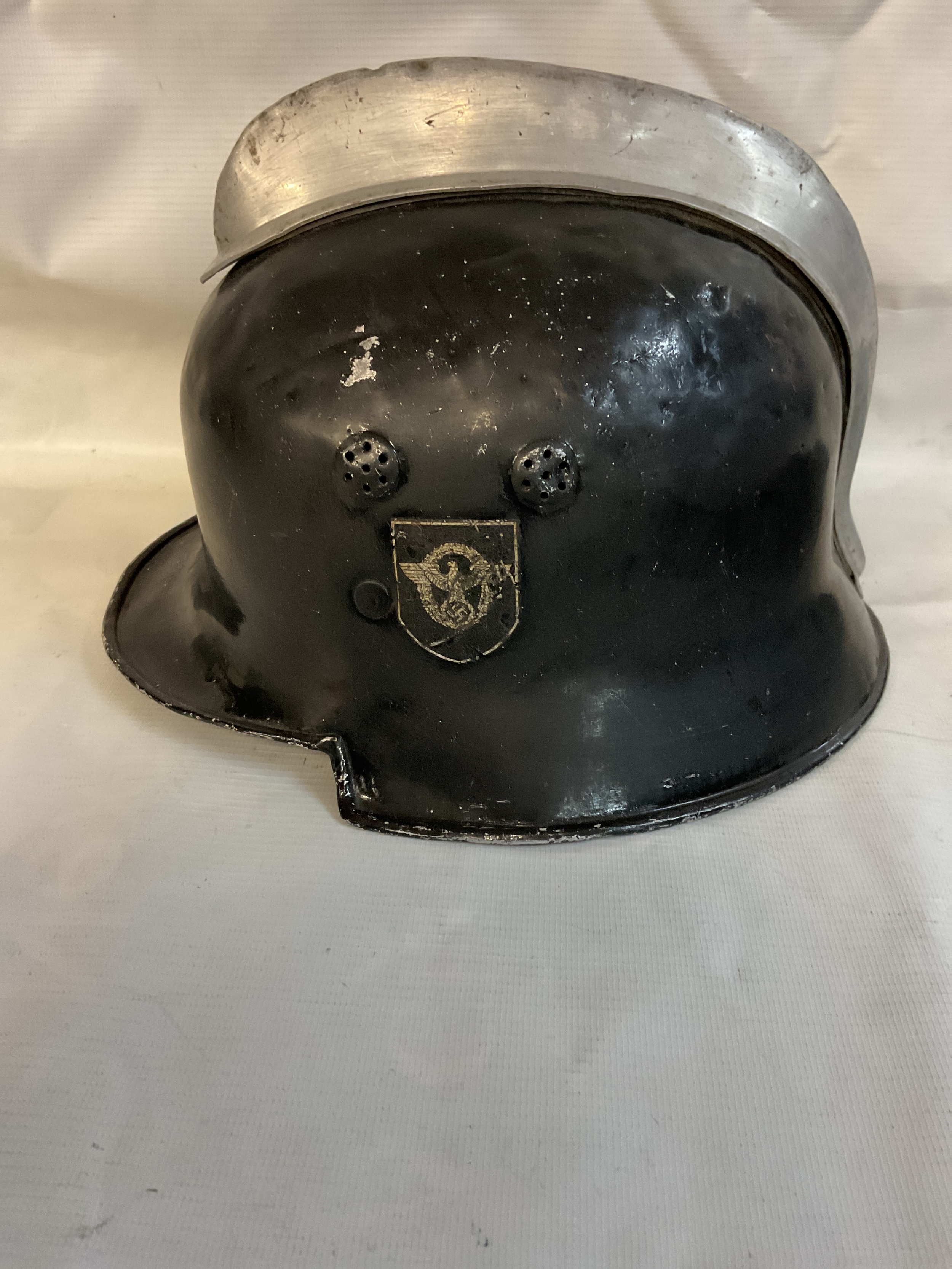 WWII German M34 Square-dip Fire/Police Helmet, with aluminium comb, police decal to one side, nine fingered liner, and marked Werner Luning to the leather.
