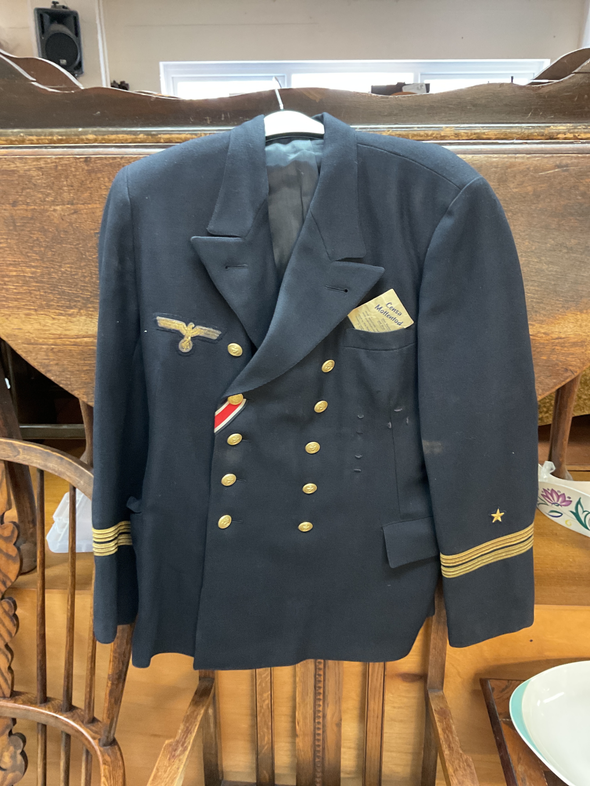 WWII German Kriegsmarine tunic with Iron Cross ribbon and breast award hoops attached along with spare button packet buttons dated 1941.