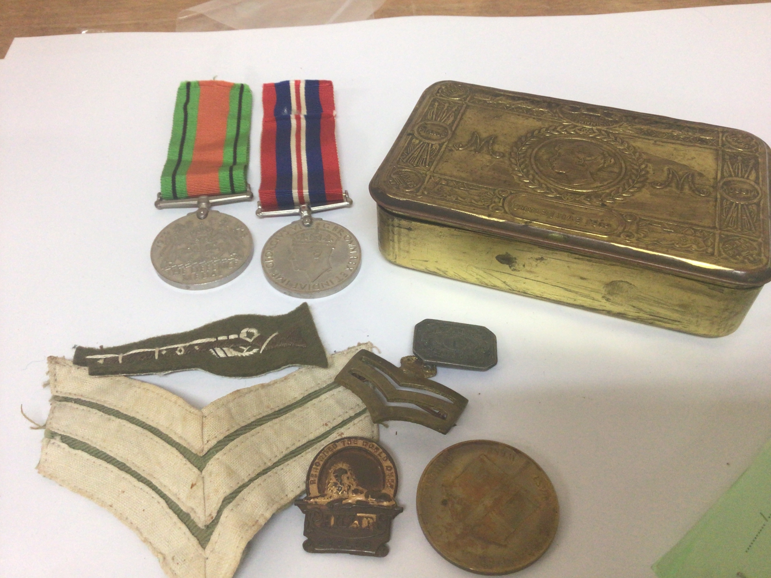 A I world war Military Christmas tin containing II world war medals and other badges. 