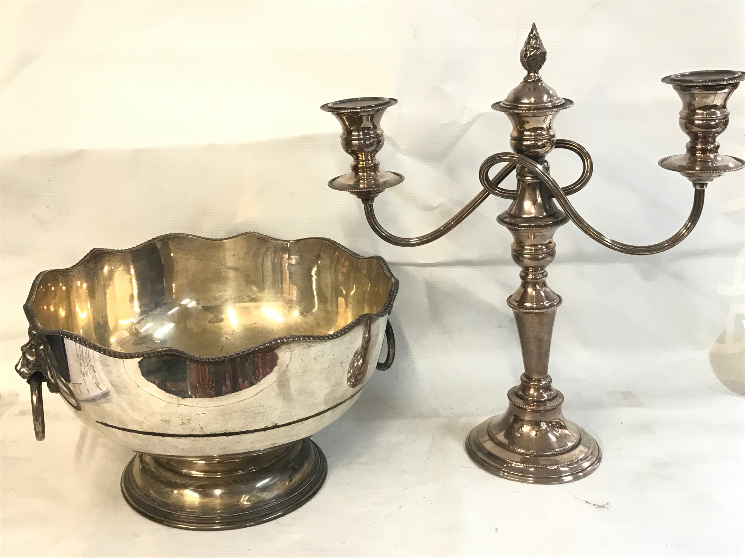 A silver plated candelabra and a bowl . 16 and 25cm tall 