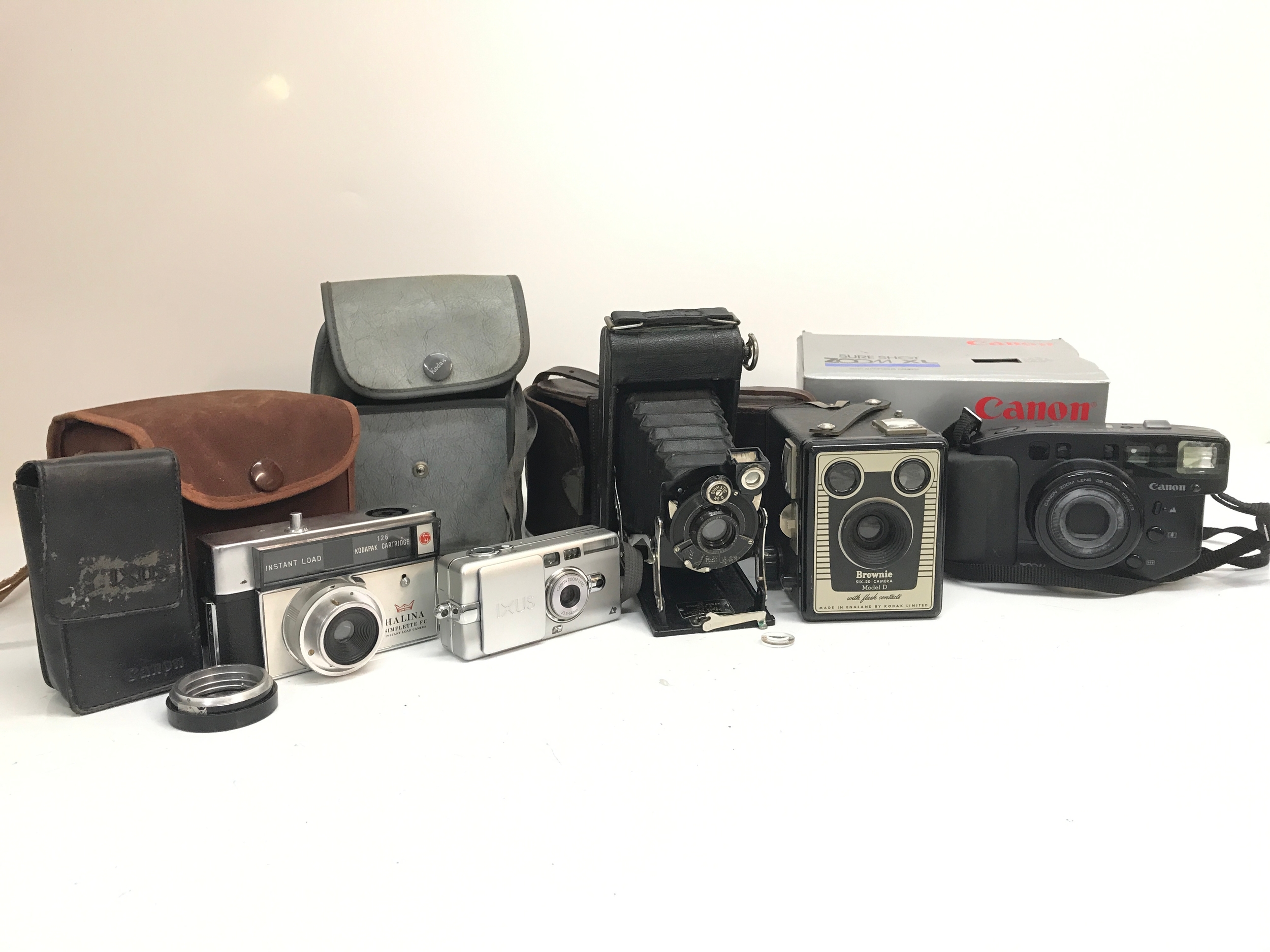 A Collection of cameras- Halina Simplette FC instant load camera, Ixus Canon zoom lens, No1 Pocket Kodak series 2, Brownie six 20 Model 2,a boxed Canon Zoom XL