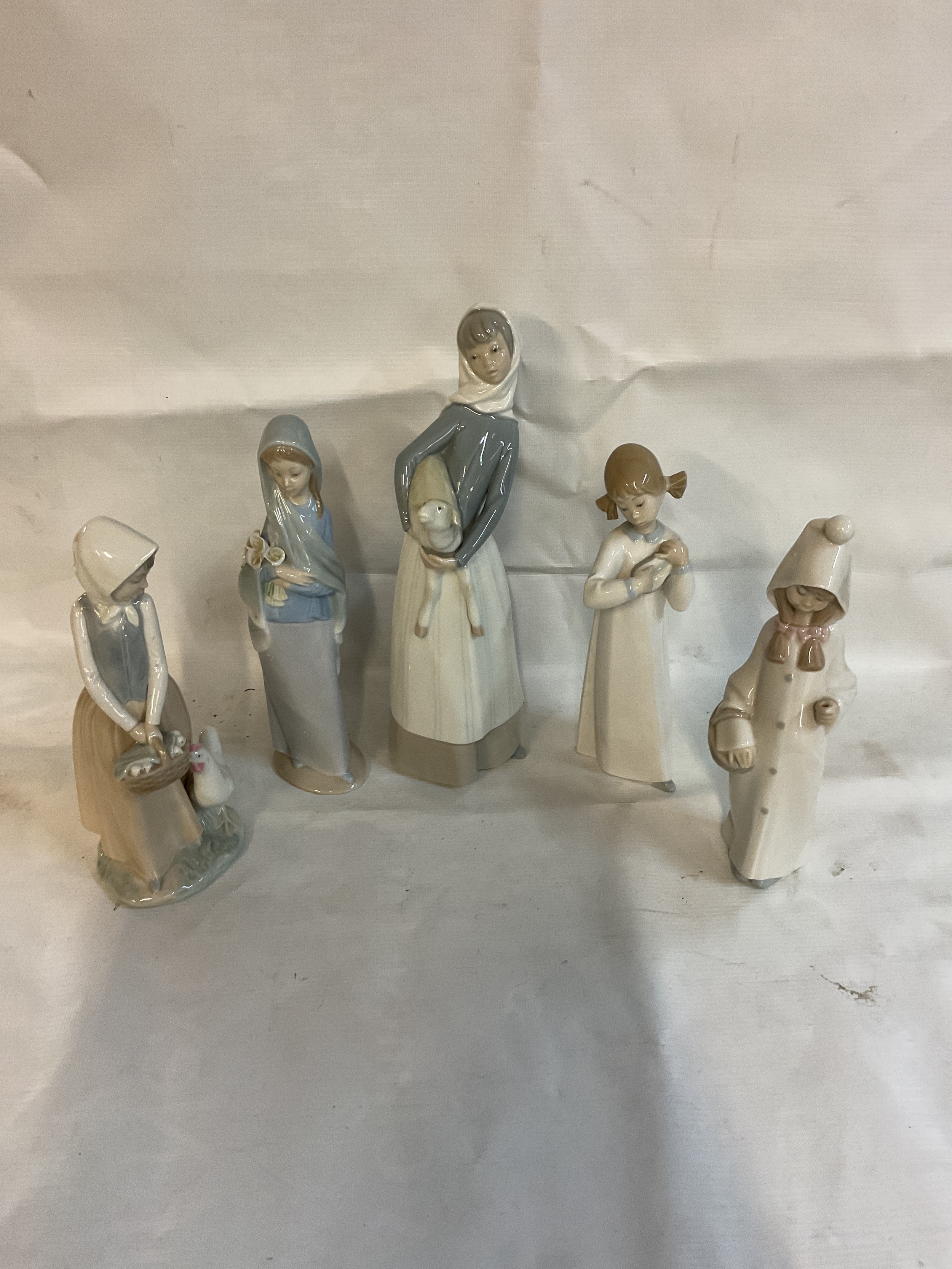Four Lladro figurines and a NAO example.