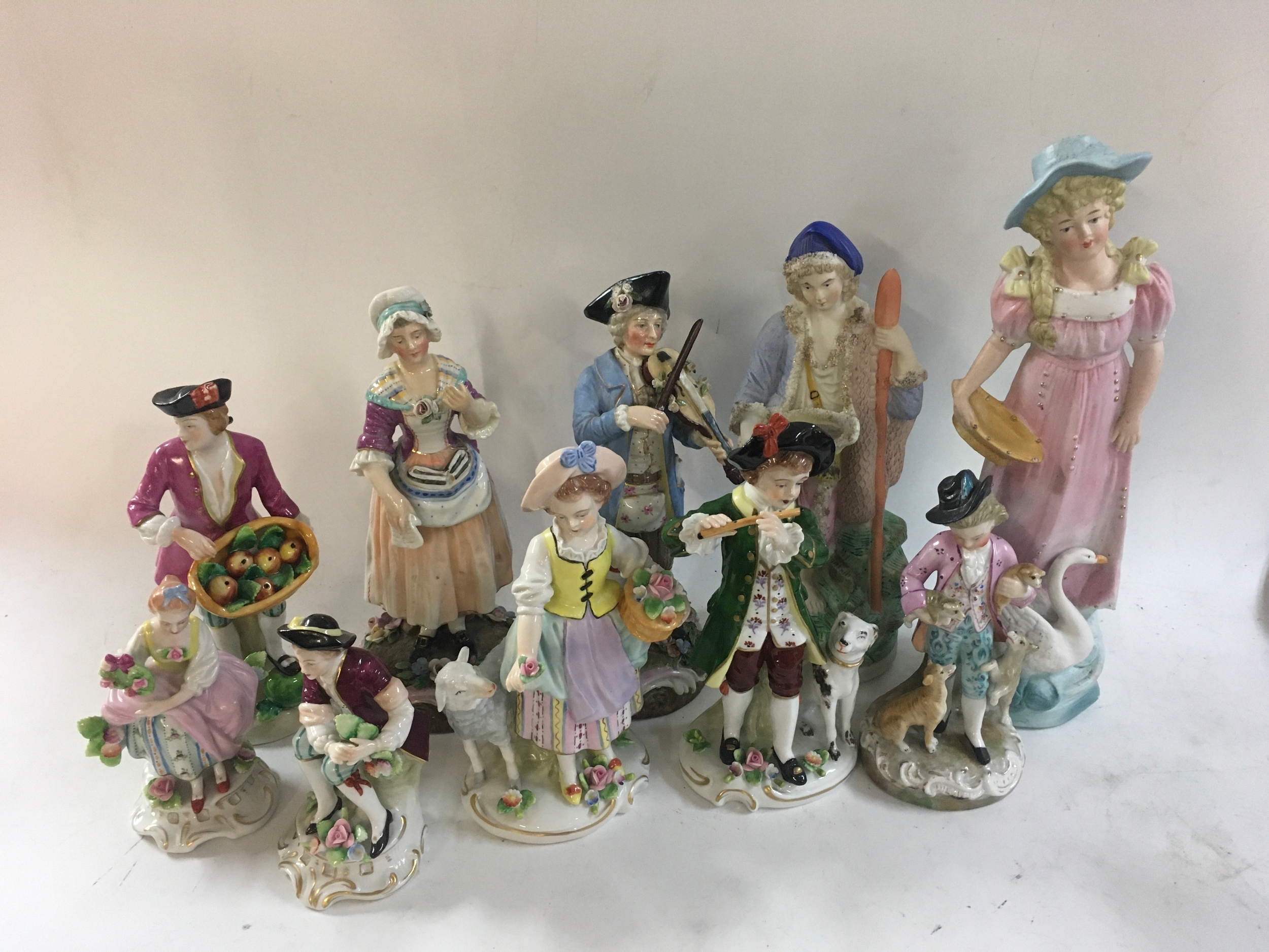 A collection of 10 18th century styled ceramic figures. 