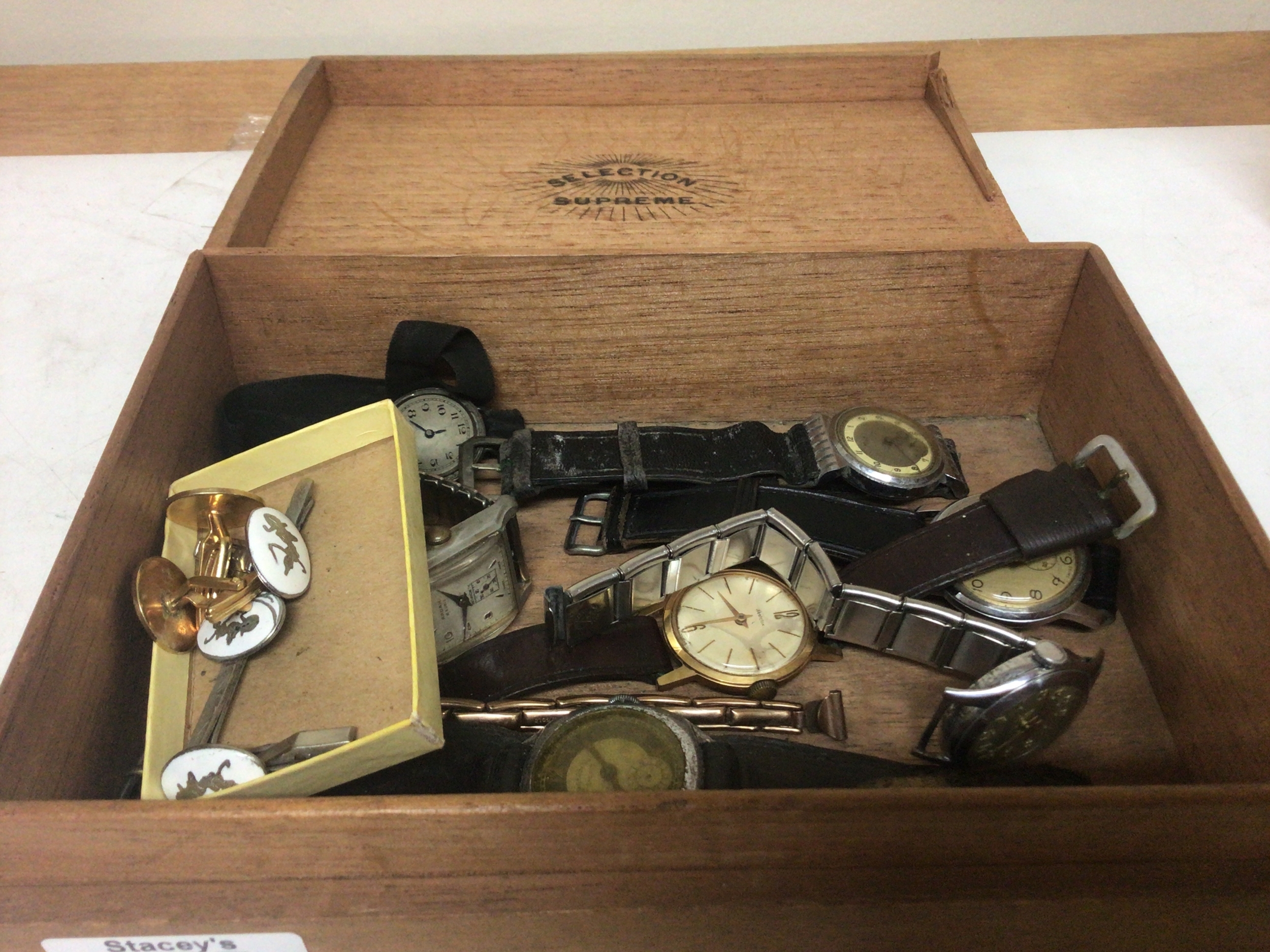  A box containing a collection of vintage watches. 