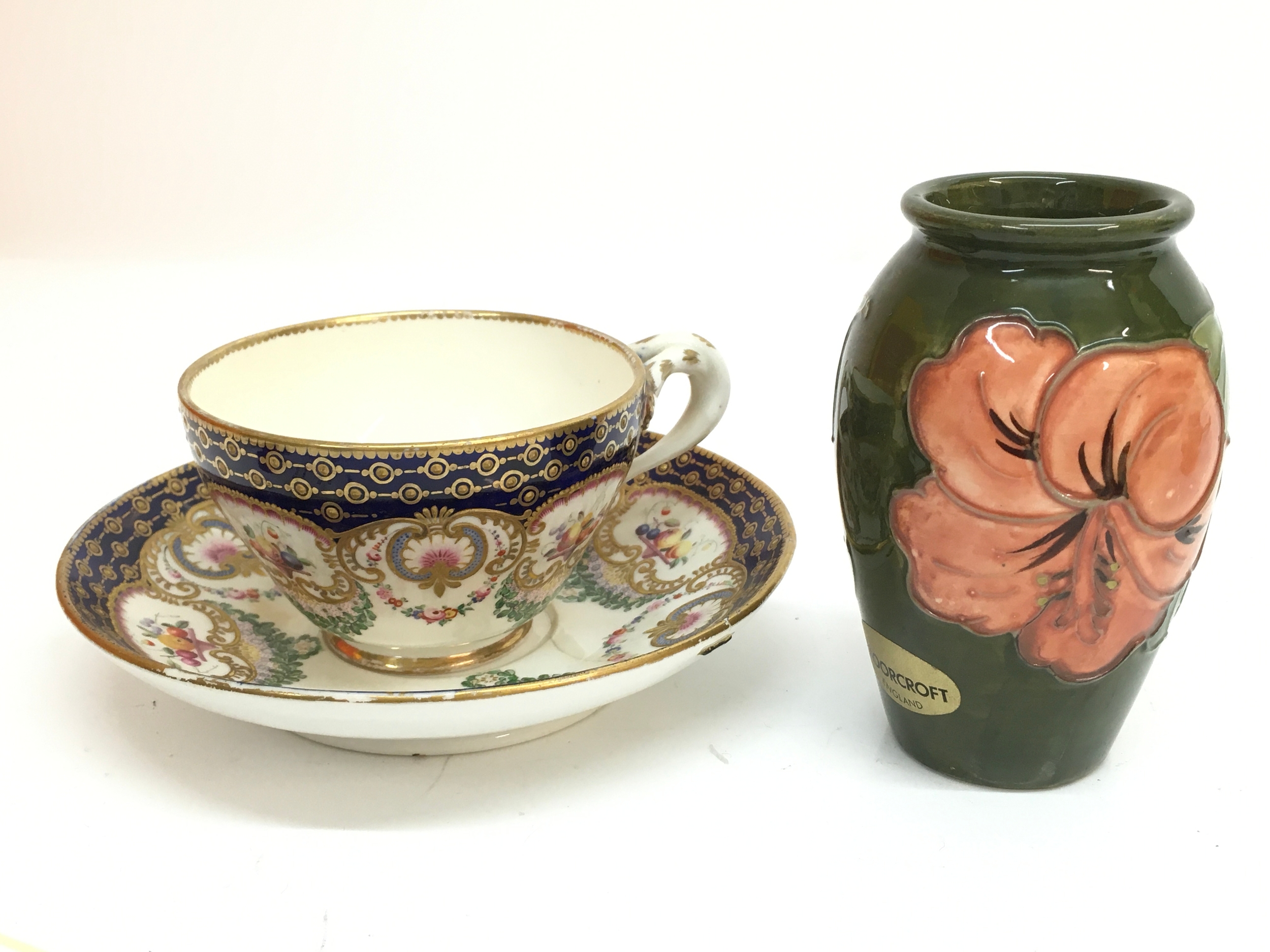 A 19th century cup and saucer and a Moorcroft vase 