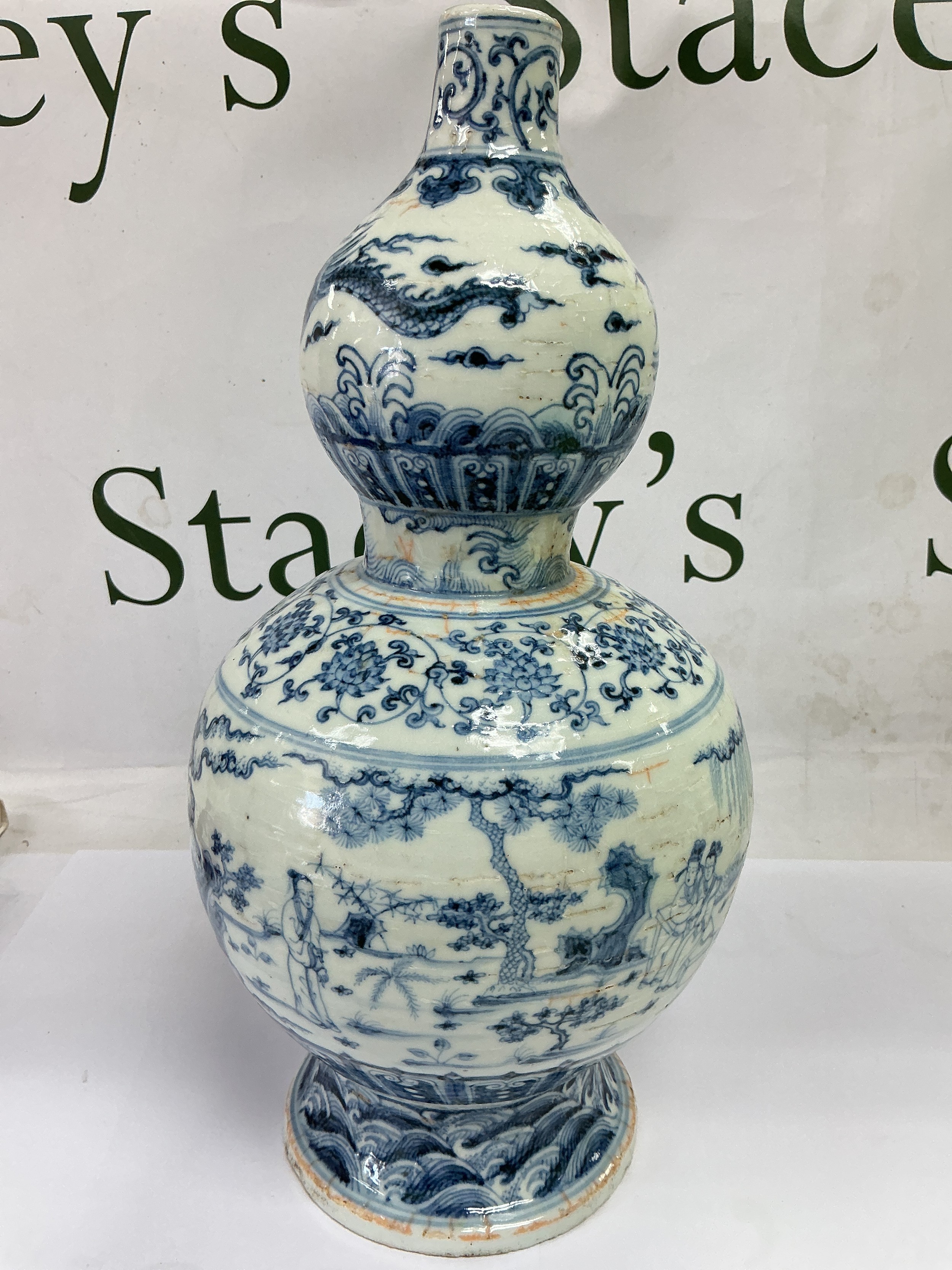 A Chinese blue and white double gourd vase decorated with figures in a landscape setting, approx height 32cm.