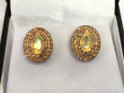 Pair of rose gilt silver opal and diamond stud earrings.