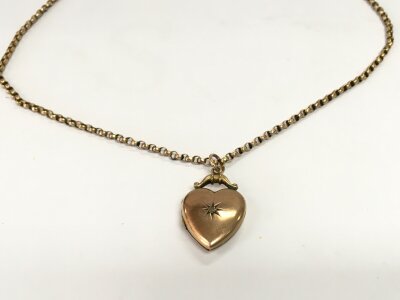 A 9ct gold chain along with a gold front and back heart shaped pendant. 7g