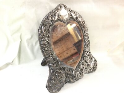 A silver hallmarked framed mirror. 870g. 24cm wide 28cm tall