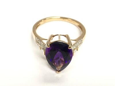 A 9ct gold dress ring set with pear shaped  amethyst and diamond set shoulders. Amethyst 6ct and diamonds 0.28ct approximately, size S