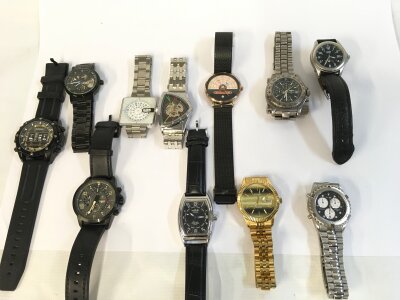 A collection of assorted men’s fashion and copy watches.