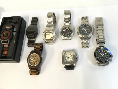A collection of assorted fashion and copy watches.
