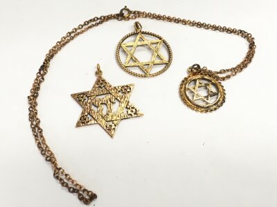 Three 9ct gold Star of David pendants (two unmarked). 18.3G