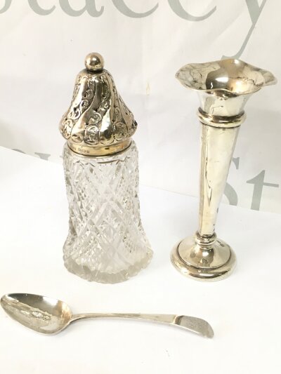 A silver vase, sifter, spoons. 112g total silver weight approximately