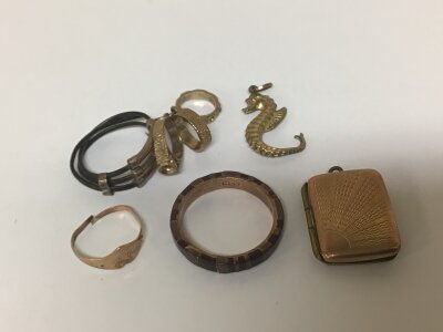 A 9carat gold ring stone set other small rings and charms and a gold front and back locket.