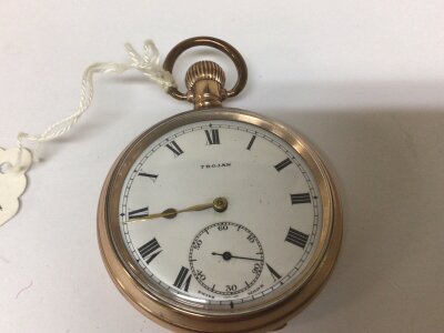 A Gold plated button wind pocket watch maker Trojan seen working.